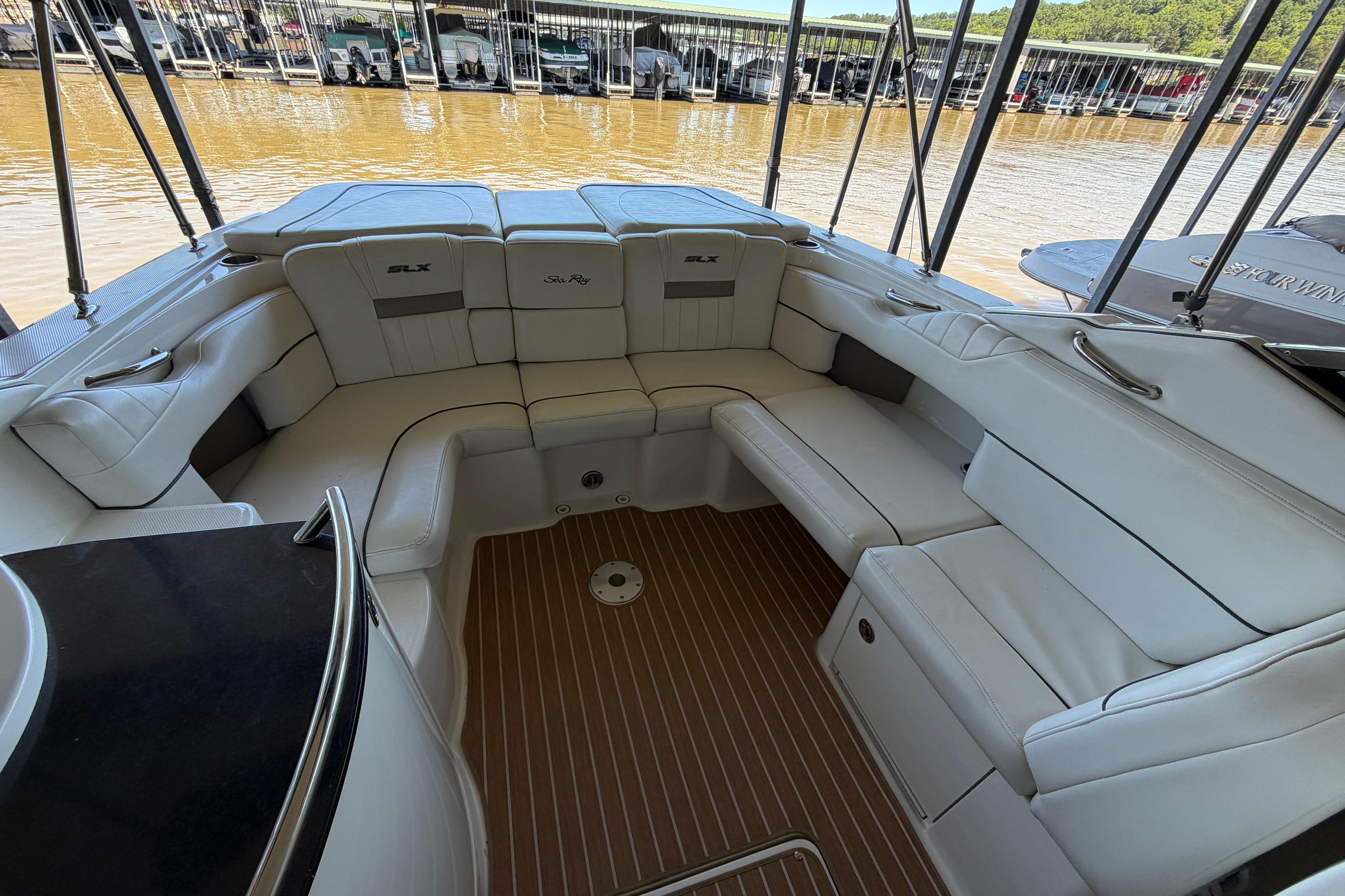 2007 Sea Ray 270 SLX boat interior with white seating and wood flooring at a marina.