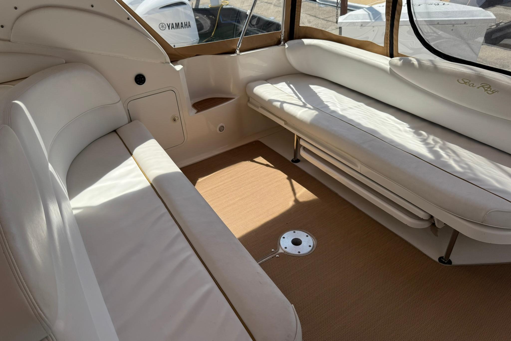 Interior of 2001 Sea Ray 340 Sundancer boat with beige seating and carpet.