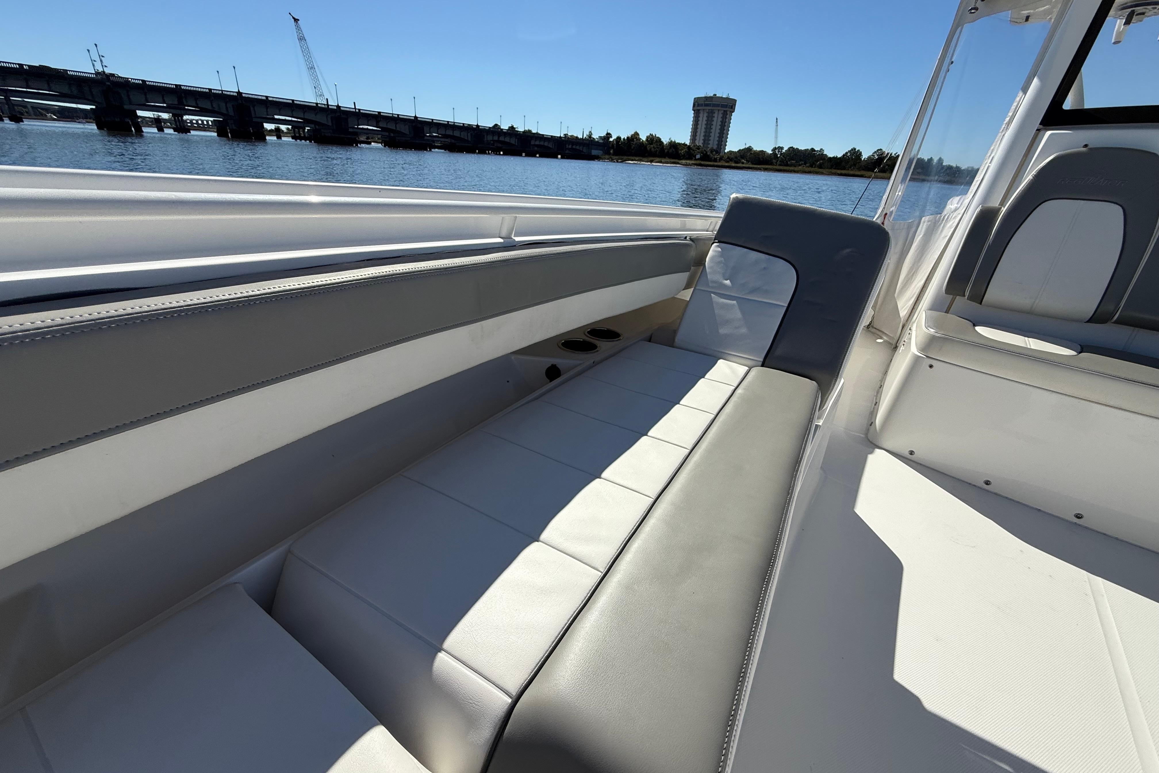 2022 Regulator 34 boat interior with comfortable seating, overlooking a scenic waterfront.