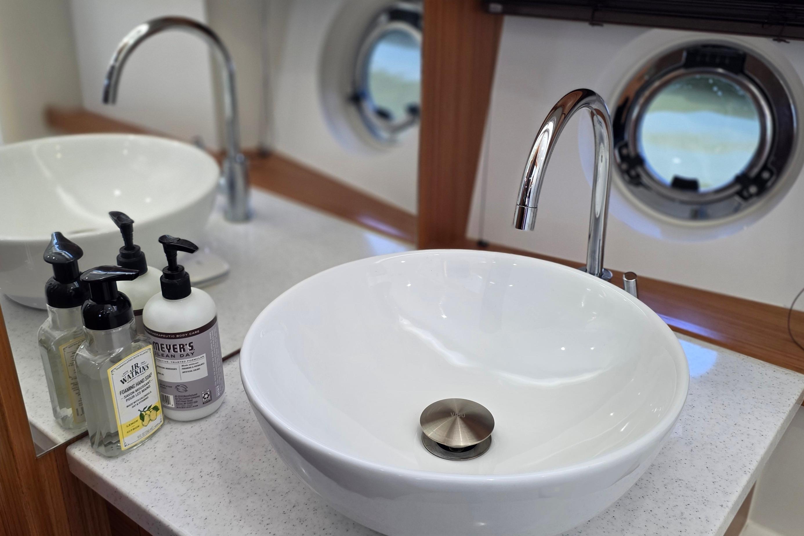 Modern bathroom sink with chrome faucet on Greenline 40 yacht, 2023 model.