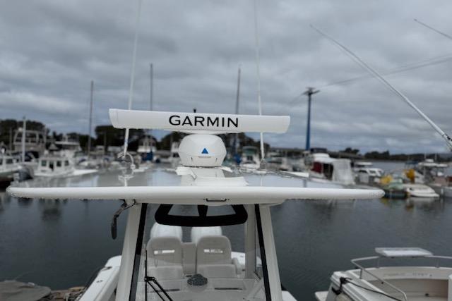 2025 Regulator 28 boat with Garmin radar, docked in a marina under cloudy skies.