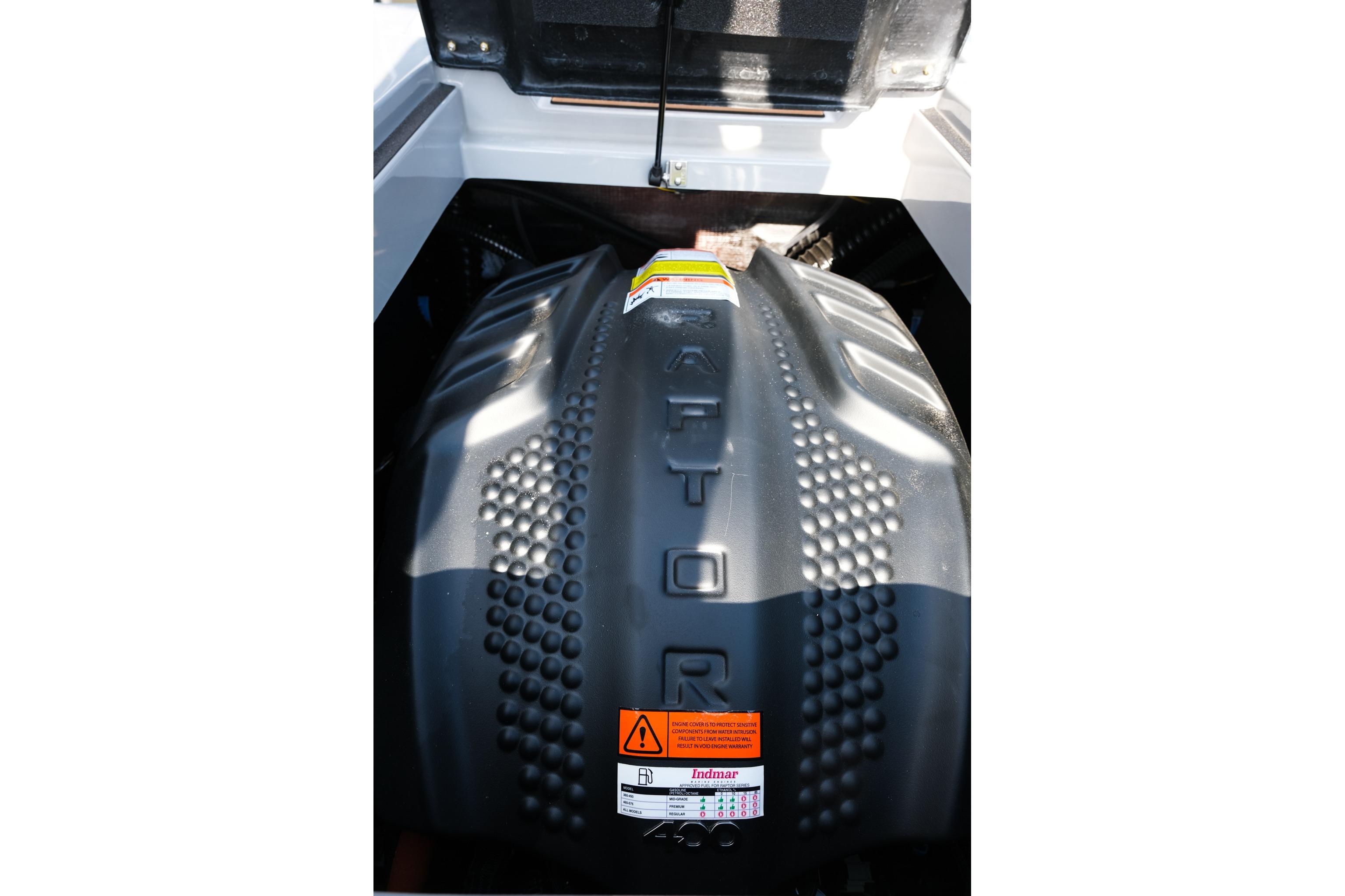 2023 Moomba Mondo boat engine, featuring a Raptor cover with safety labels.