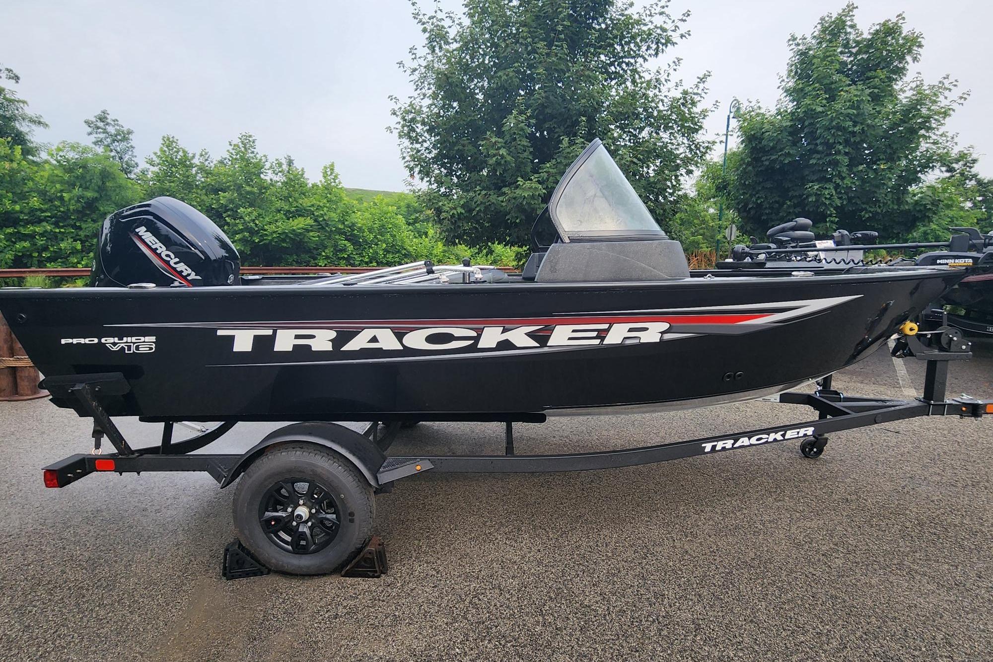 2026 Tracker Pro Guide V-16 WT boat on trailer, parked outdoors.