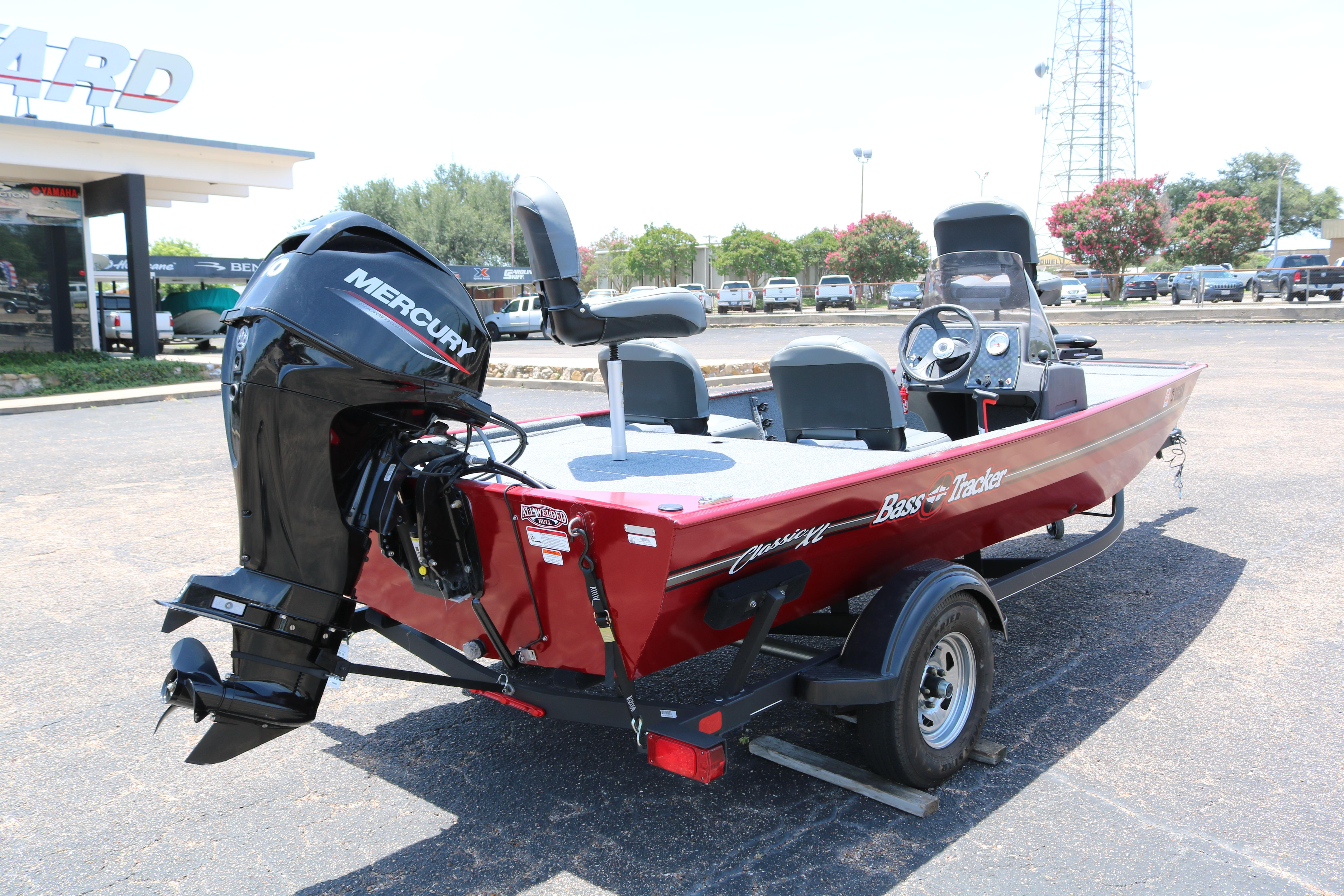 2021 Tracker Bass Tracker Classic XL boat with Mercury engine in a parking lot.