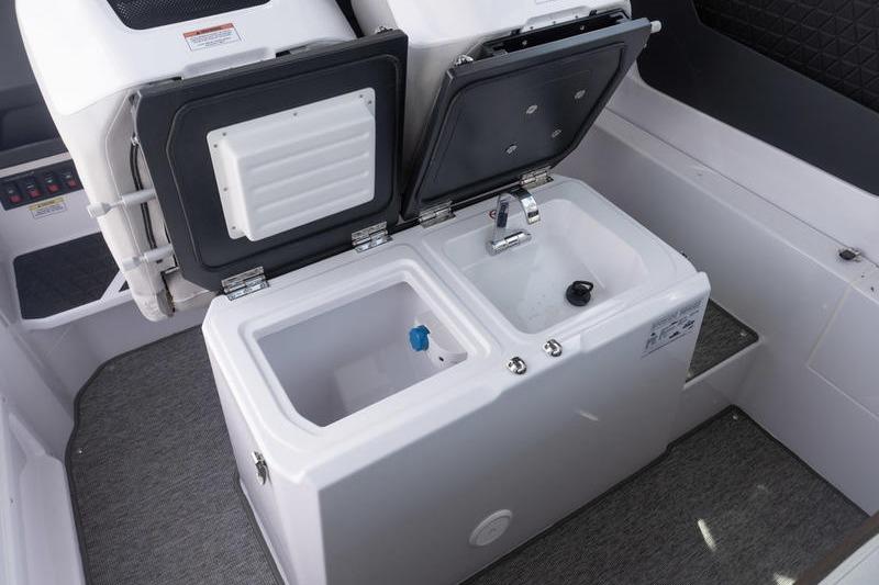 2025 Axopar 29 XC Cross Cabin interior with open storage compartments and sink.