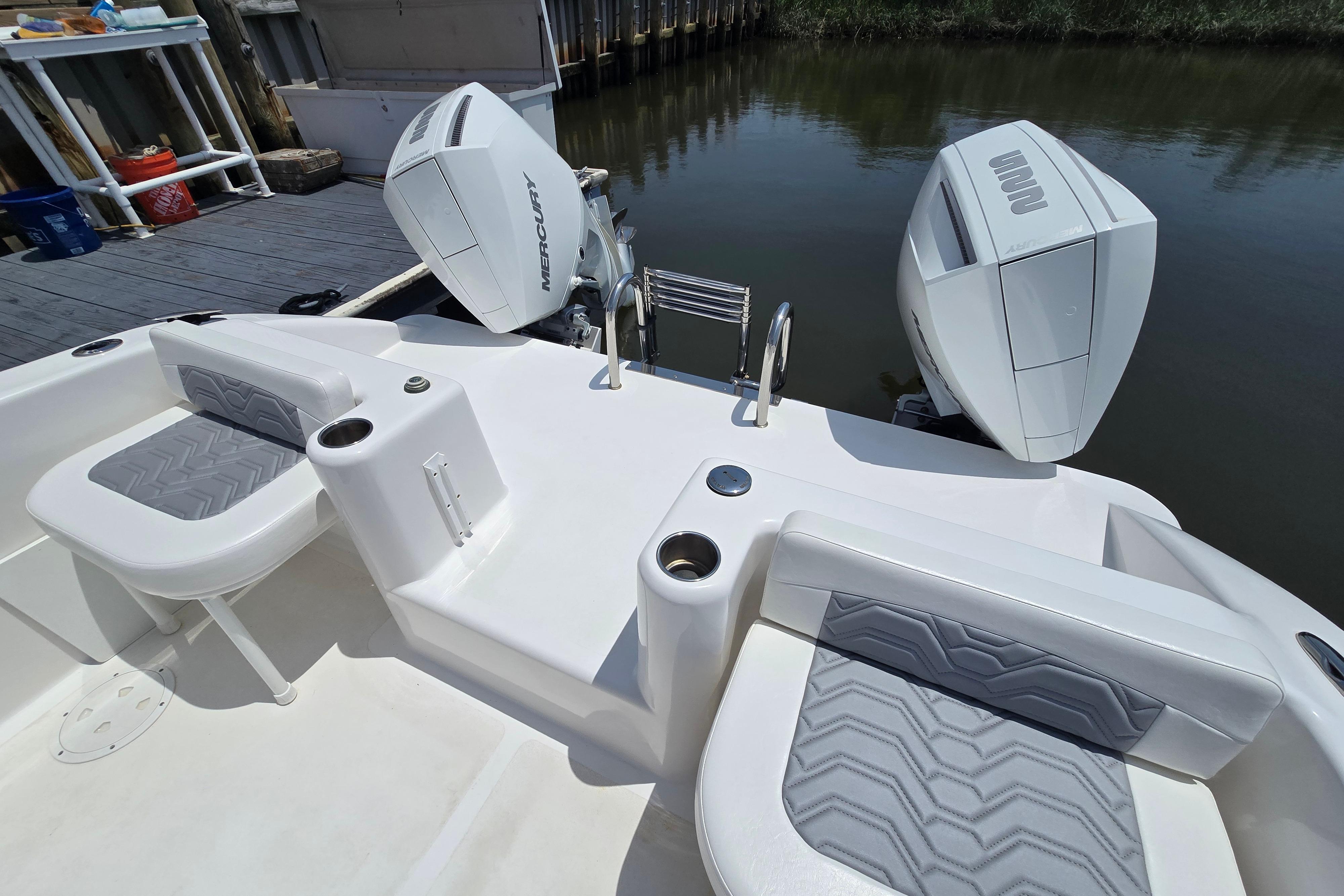2021 Twin Vee 280 GFX CC boat with dual Mercury outboard engines at dock.