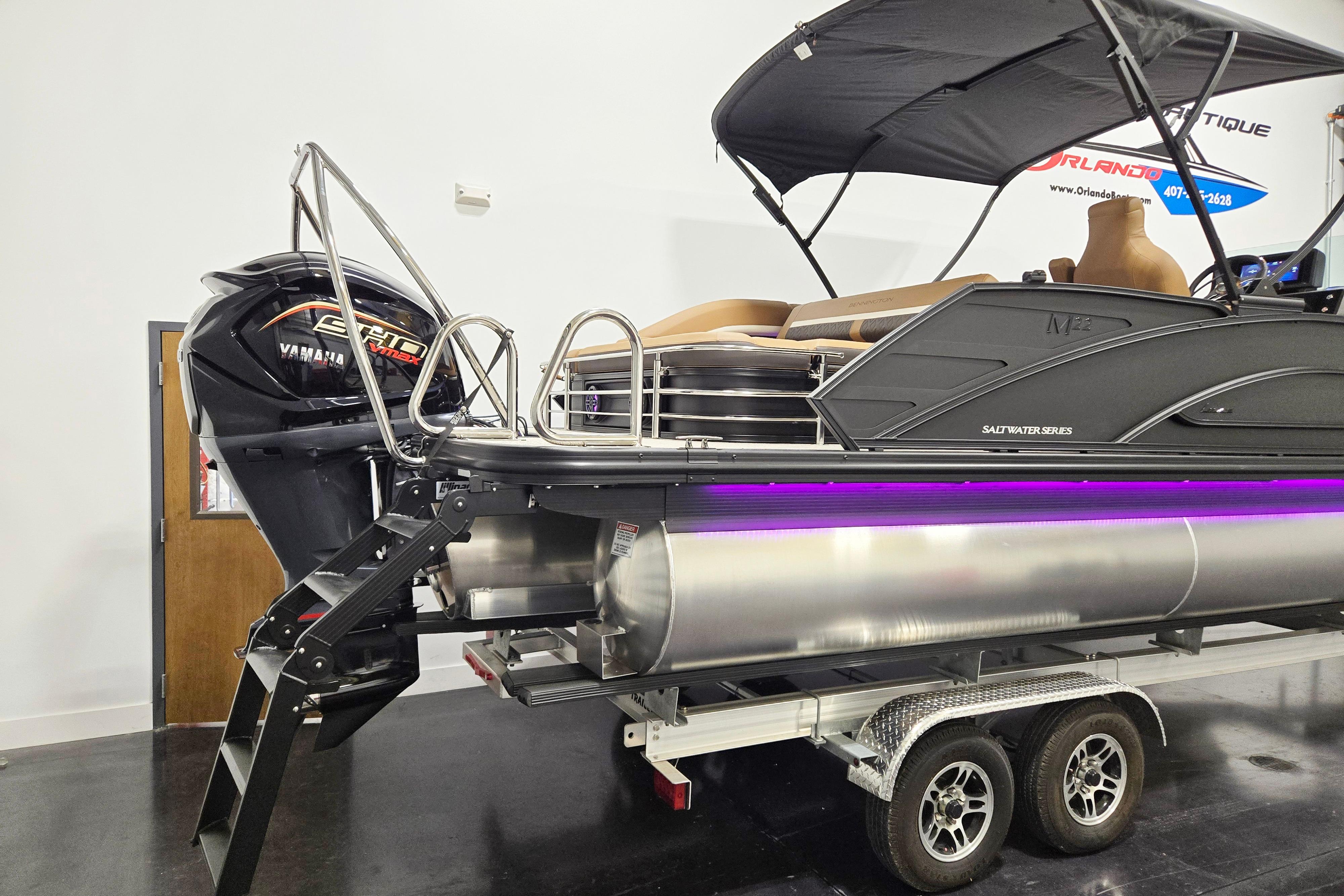 2026 Bennington 22 M Swingback pontoon boat with Yamaha engine, displayed indoors.