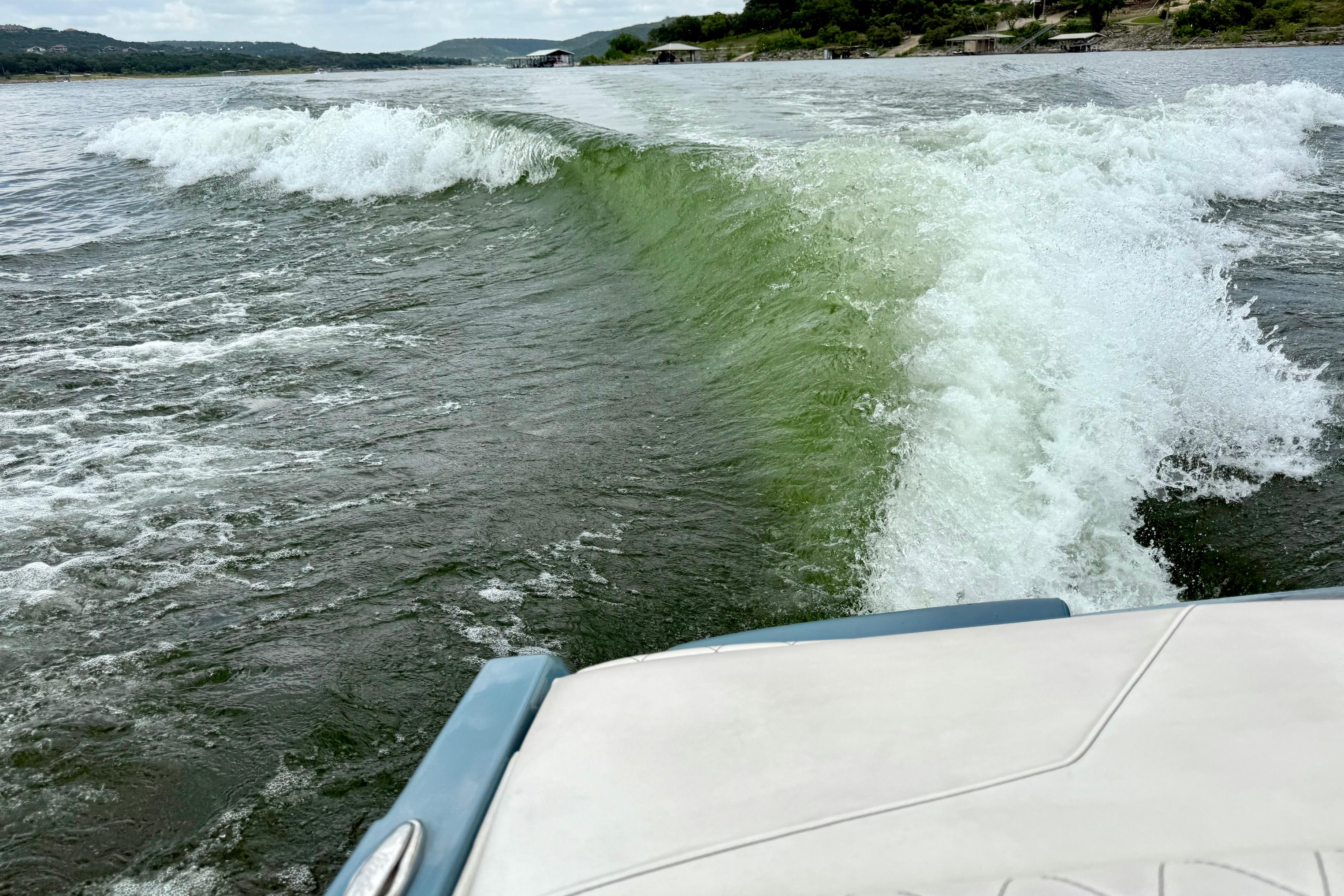 Wake created by a 2021 Tige Z3 boat on a scenic lake.