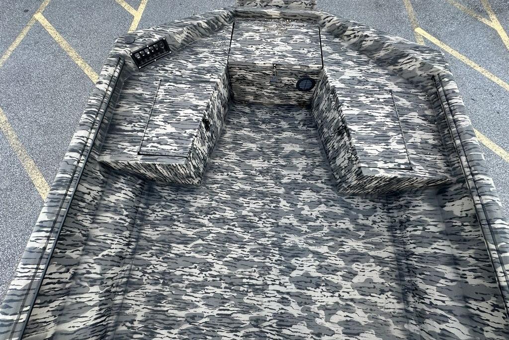 2025 Havoc 1860 boat interior with camouflage pattern, featuring storage compartments.