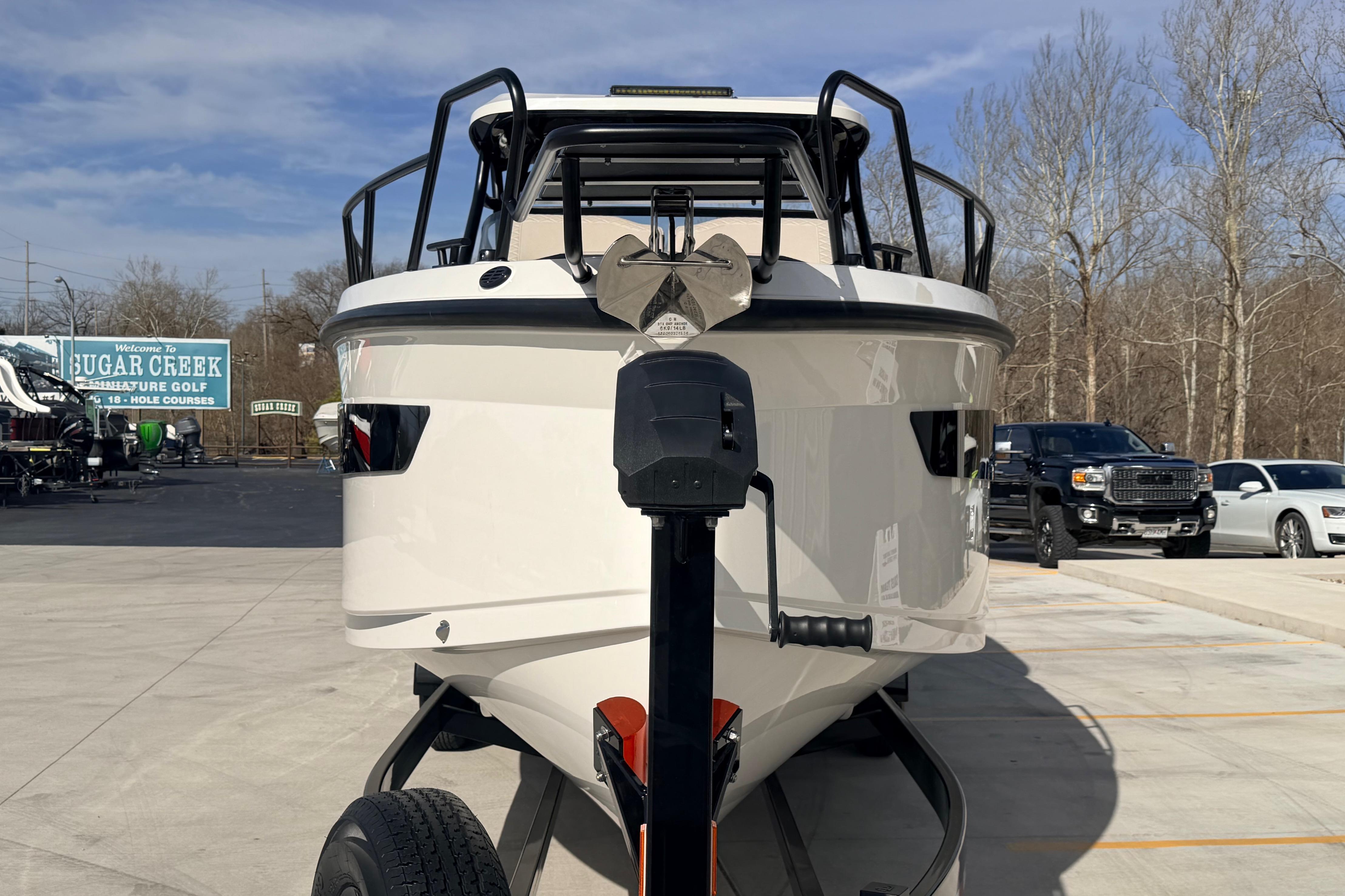 Front view of 2026 Navan S30 boat on trailer at dealership.