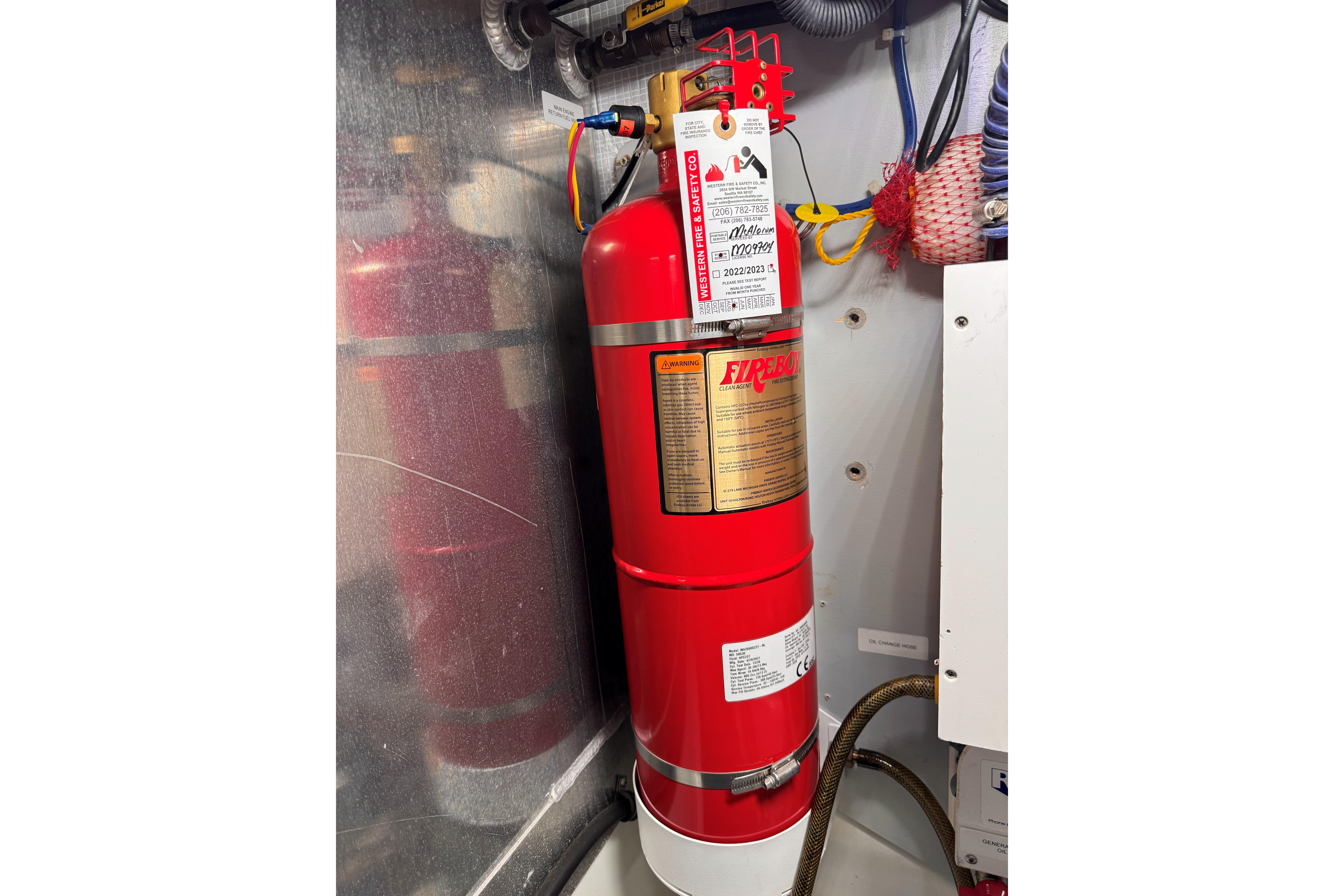 Fire extinguisher in 2007 American Tug 41 engine room, mounted on wall.