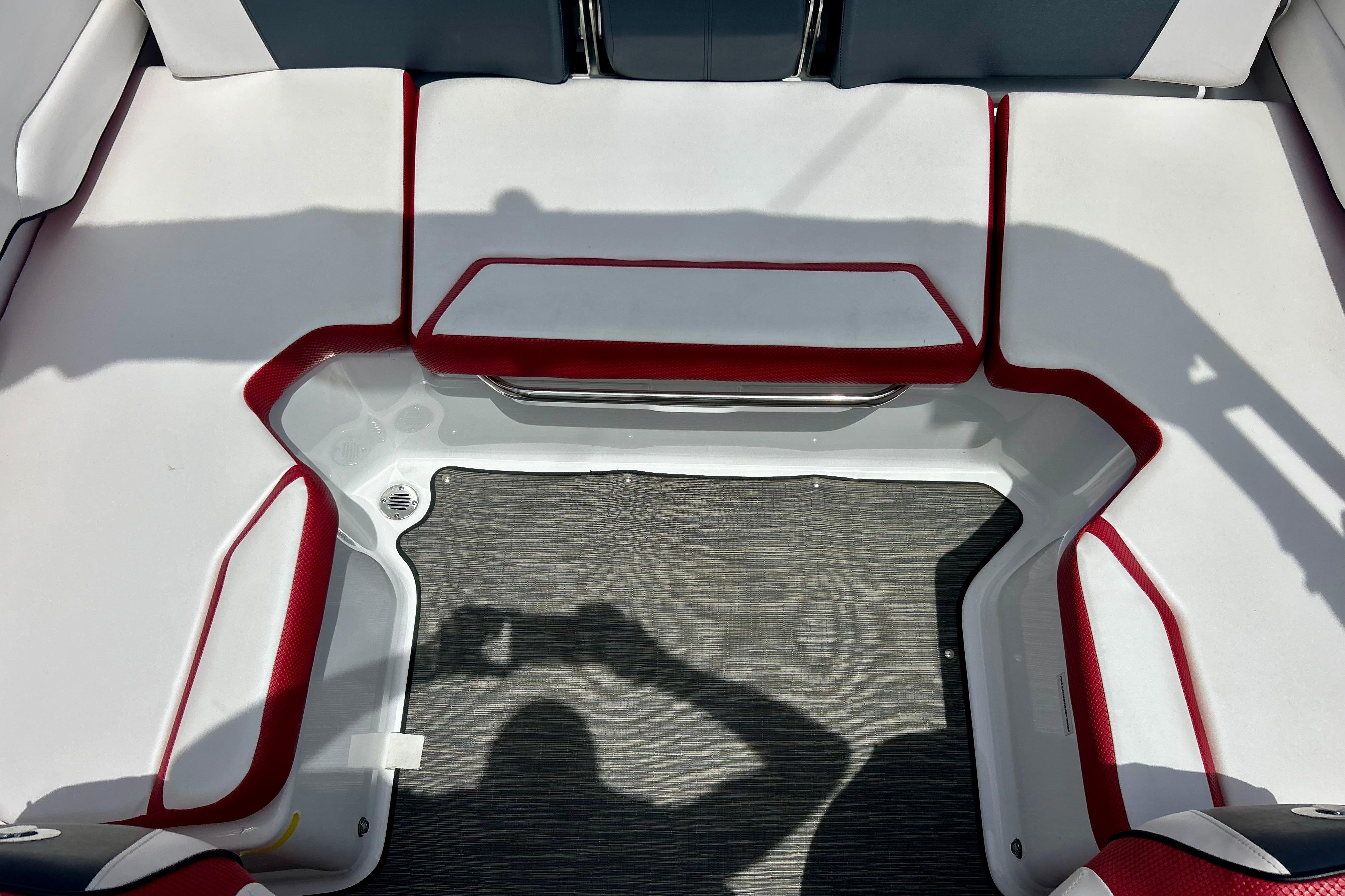 Interior seating of 2021 Scarab 195 ID boat with red and white upholstery.