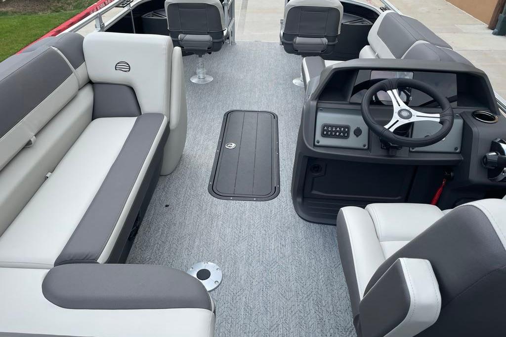 2026 Sun Tracker Fishin' Barge 22 XP3 interior with seating and steering console.