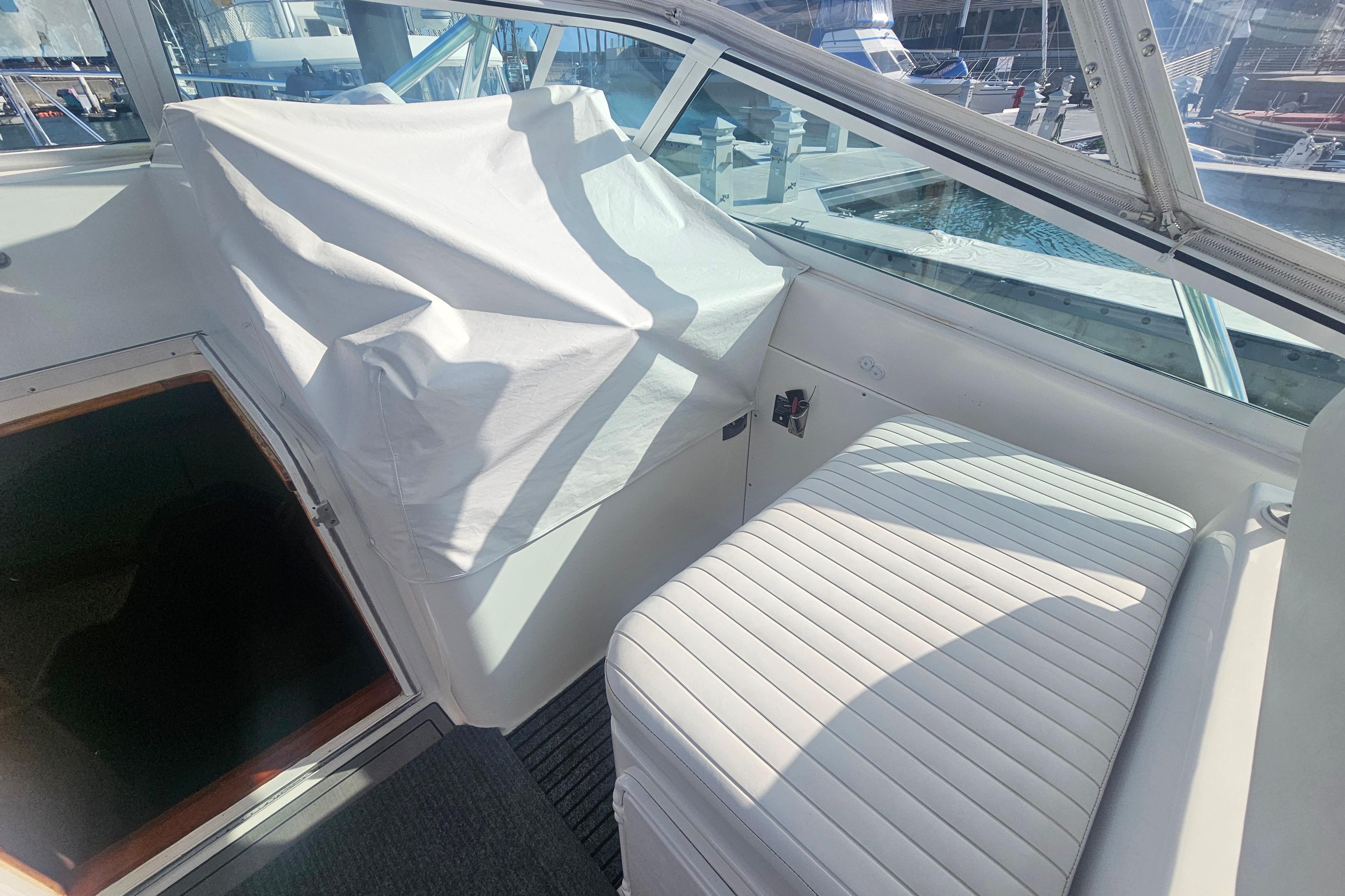 Interior of 2003 Topaz 32 Express boat with covered controls and seating.