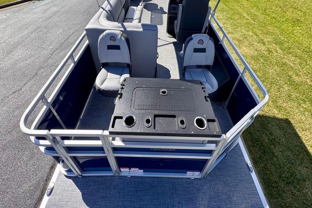 2026 Sun Tracker Sportfish 24 XP3 pontoon boat interior with seating and table.