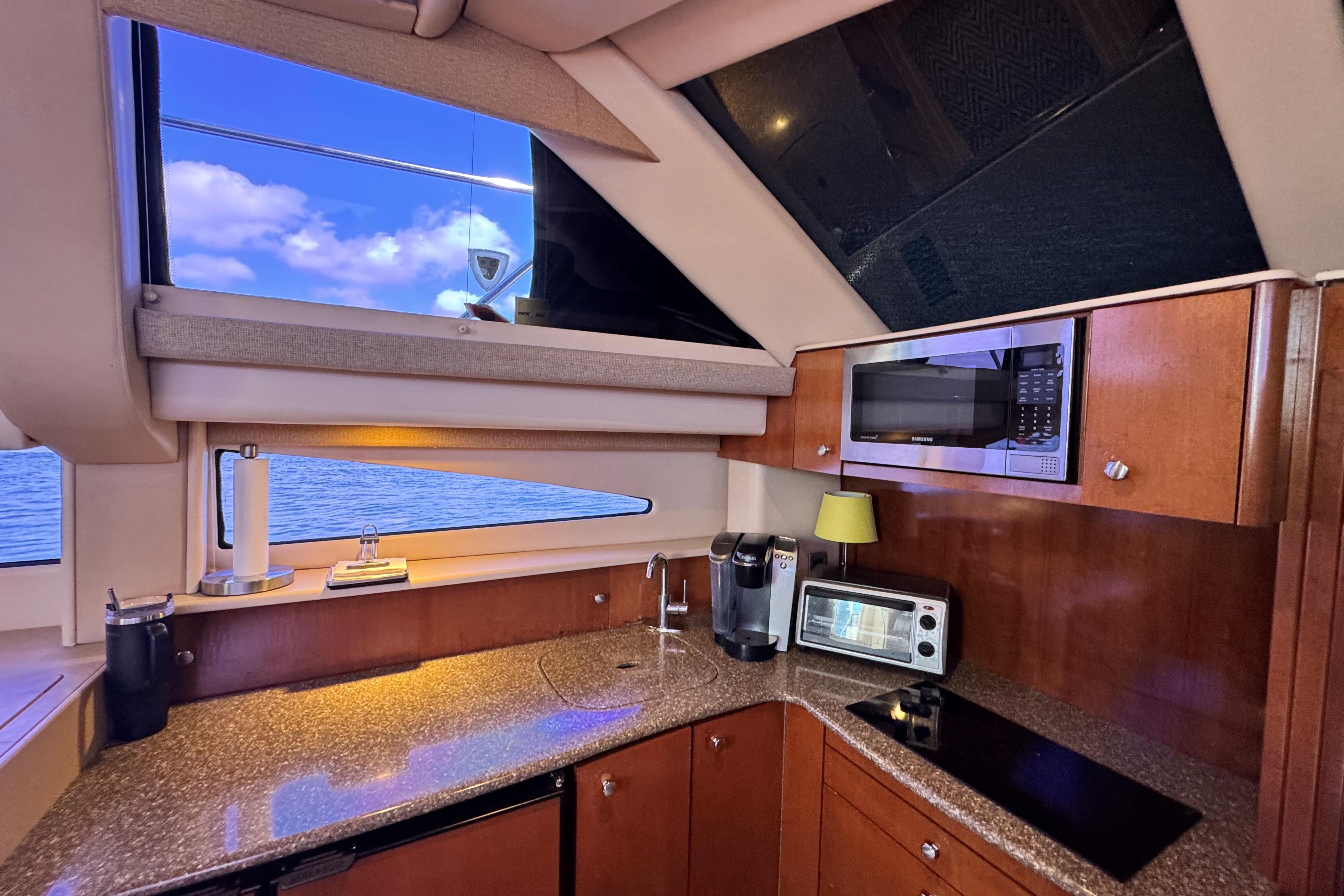 Luxurious kitchen interior of 2005 Meridian 368 Motoryacht with modern appliances and ocean view.