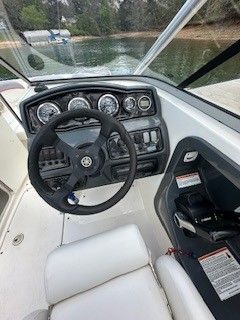 Interior view of a 2008 Yamaha AR230 boat cockpit by the water.