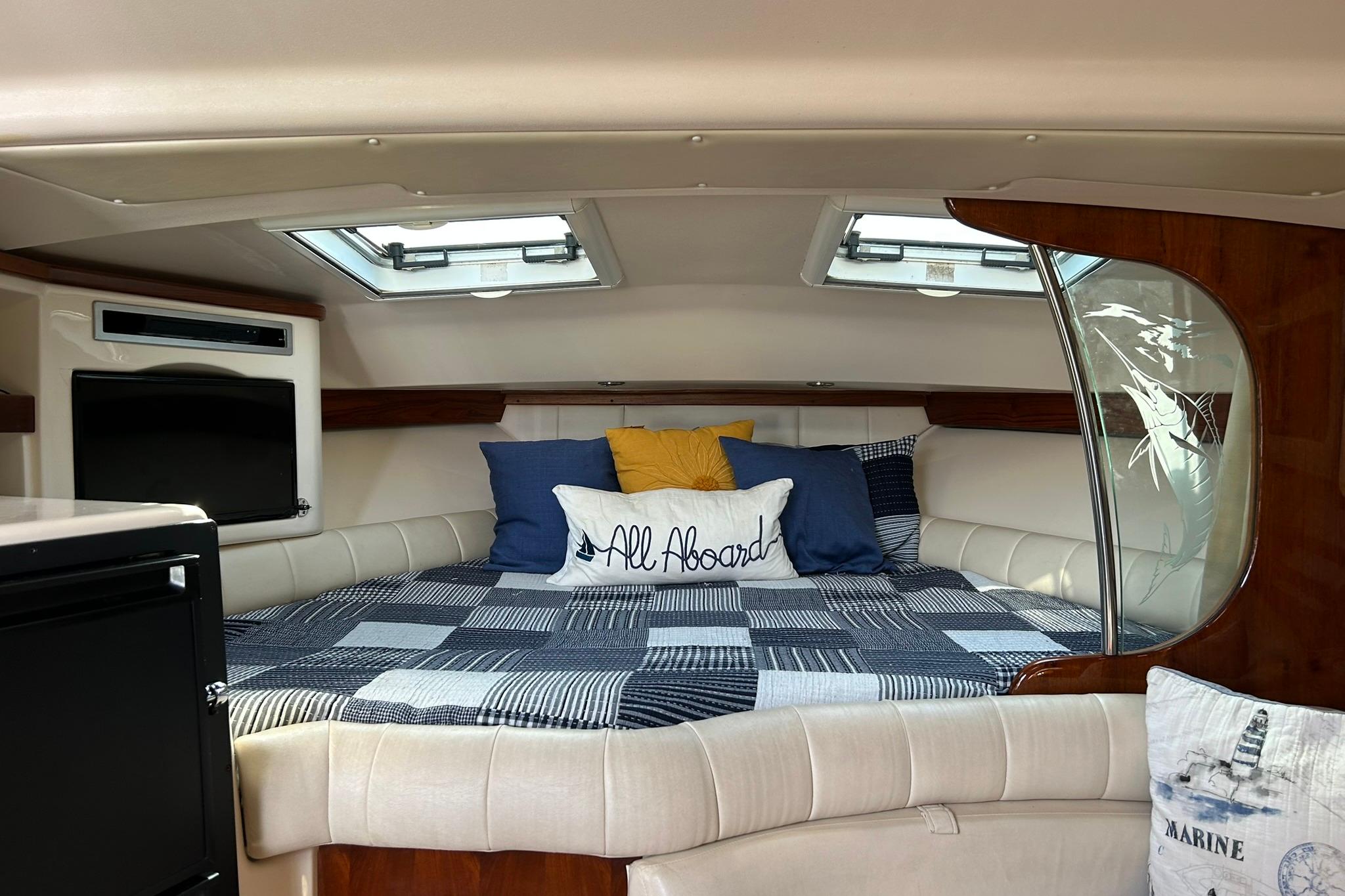 Luxurious cabin interior of 2007 Grady-White Express 360 boat with cozy bedding.