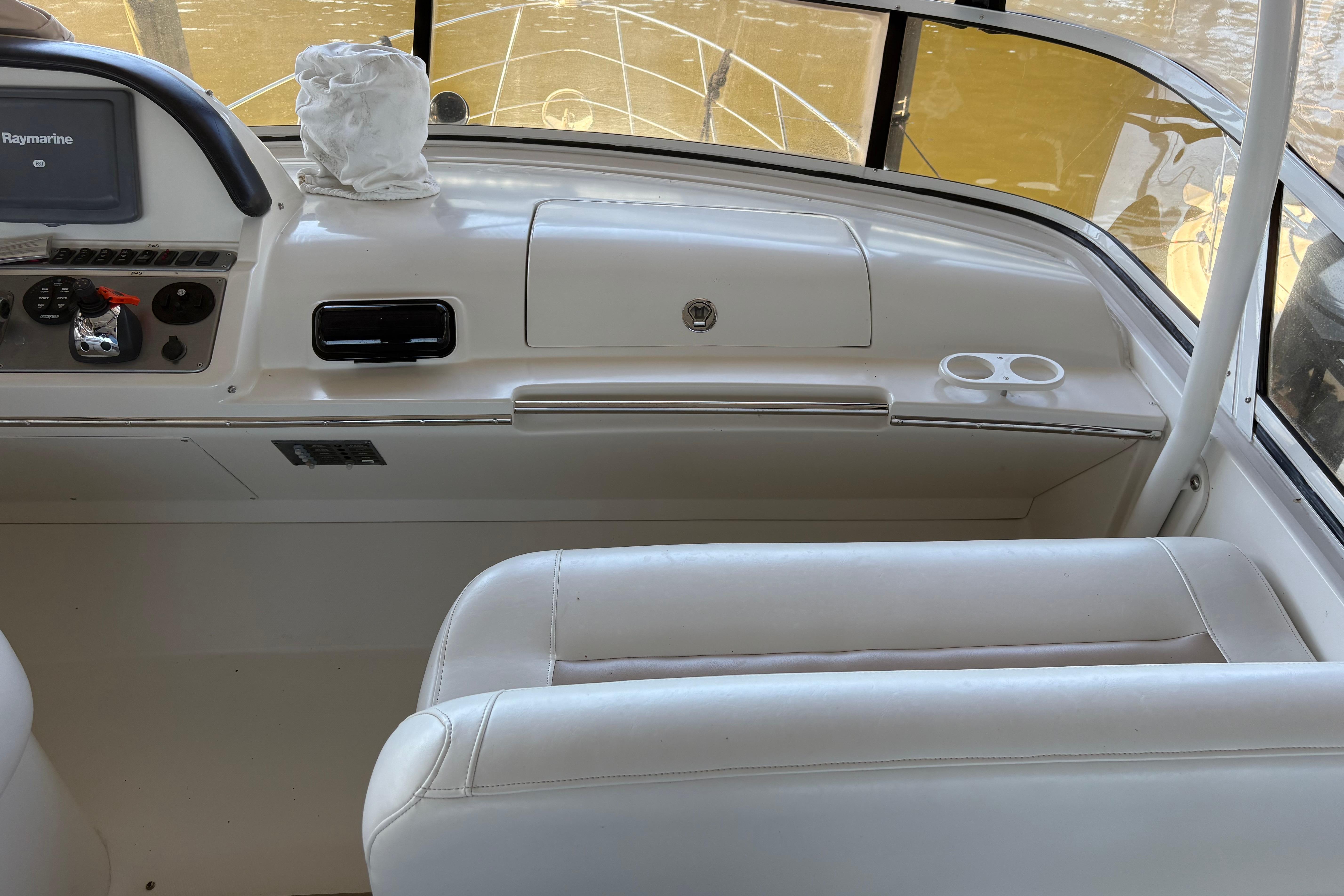 Interior of 2007 Carver 42 Super Sport yacht with white seating and dashboard.