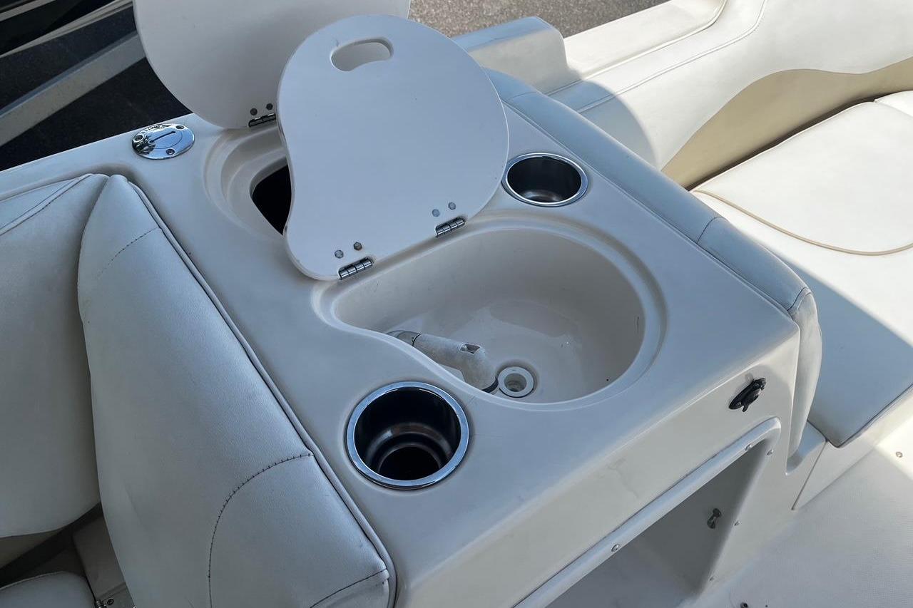 2008 Hurricane FD202 boat interior with cup holders and storage compartment.