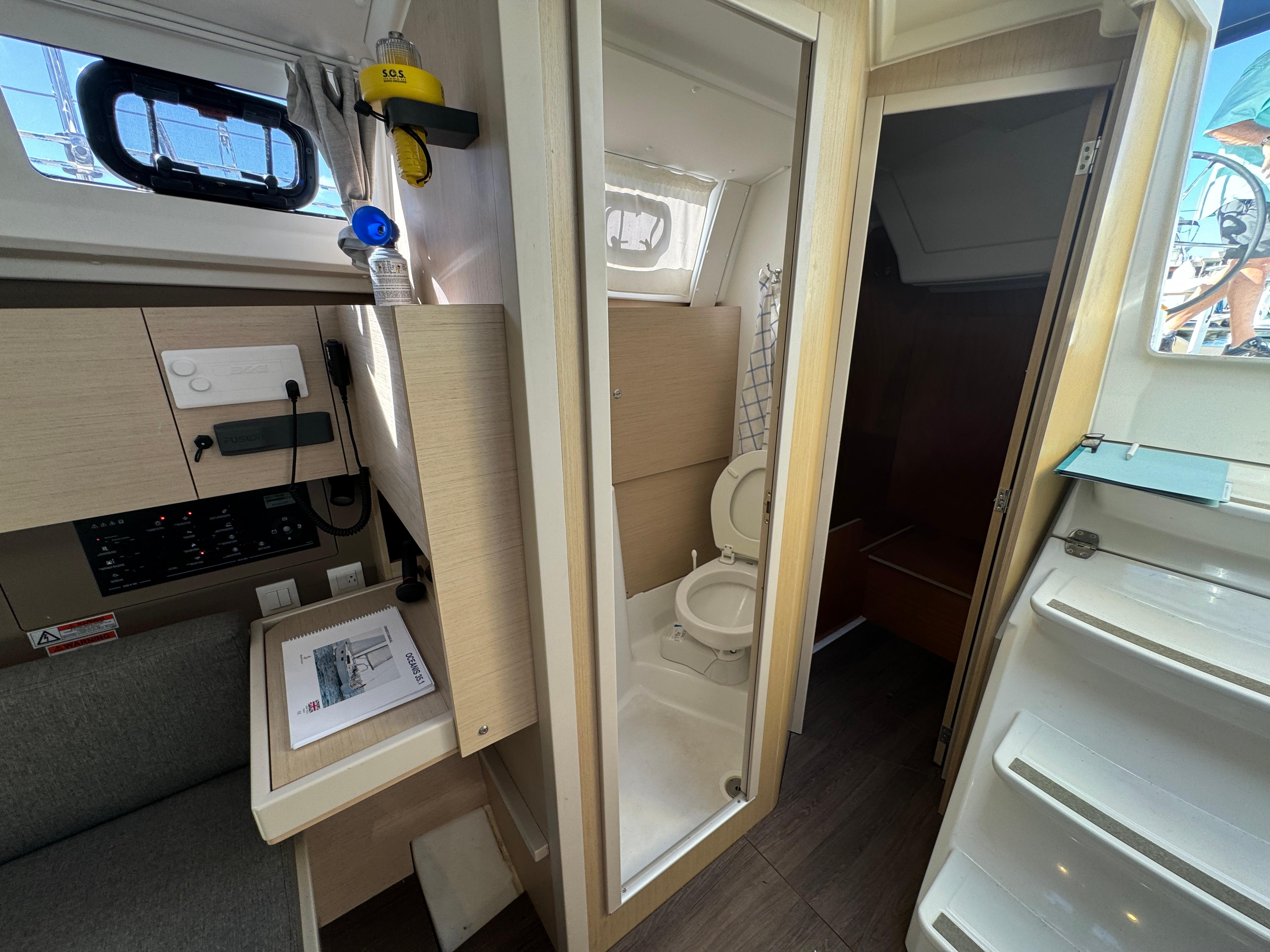 Interior of 2021 Beneteau Oceanis 35.1 yacht showing bathroom and navigation area.