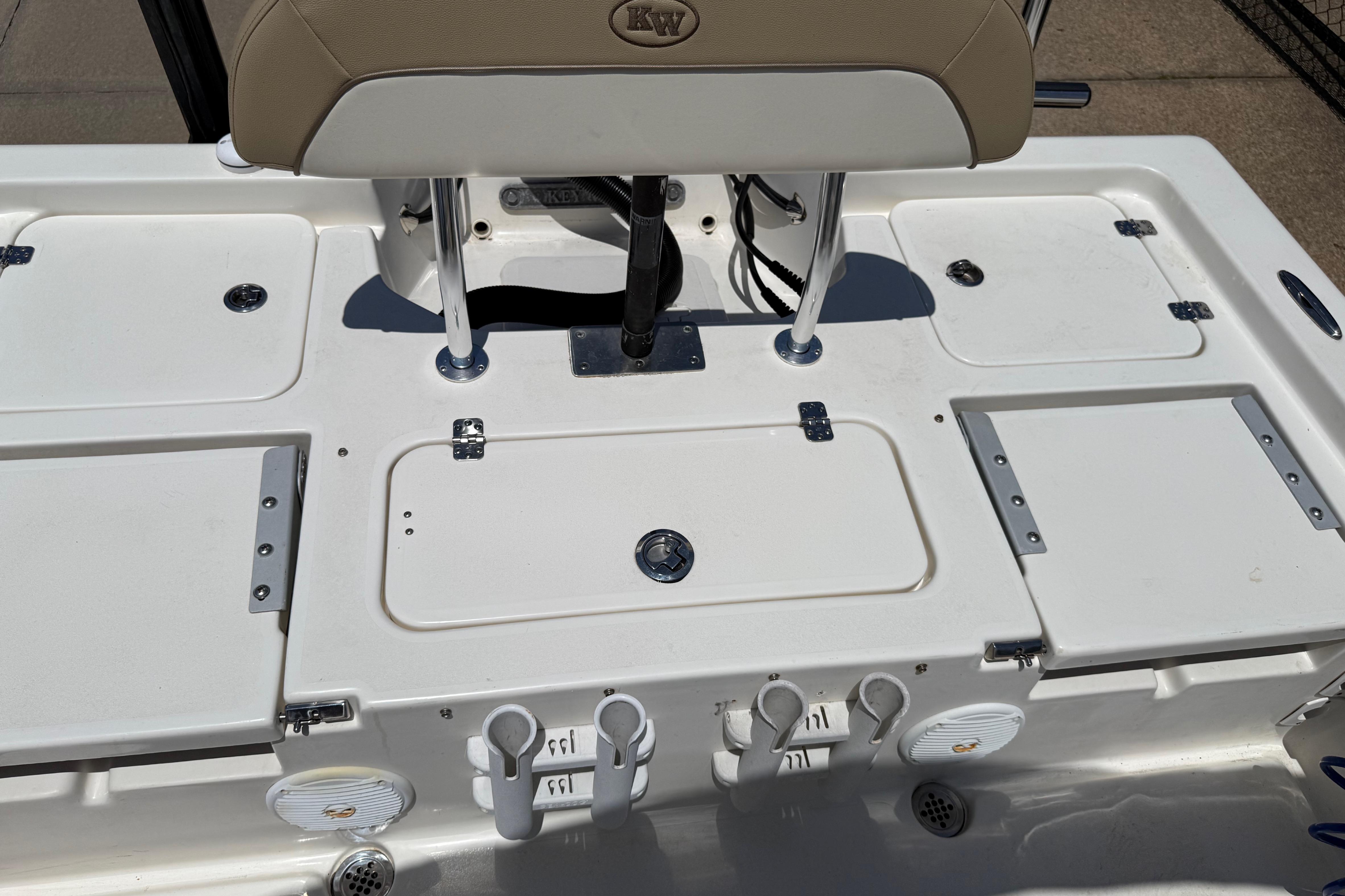 2019 Key West 230 Bay Reef boat deck with storage compartments and rod holders.