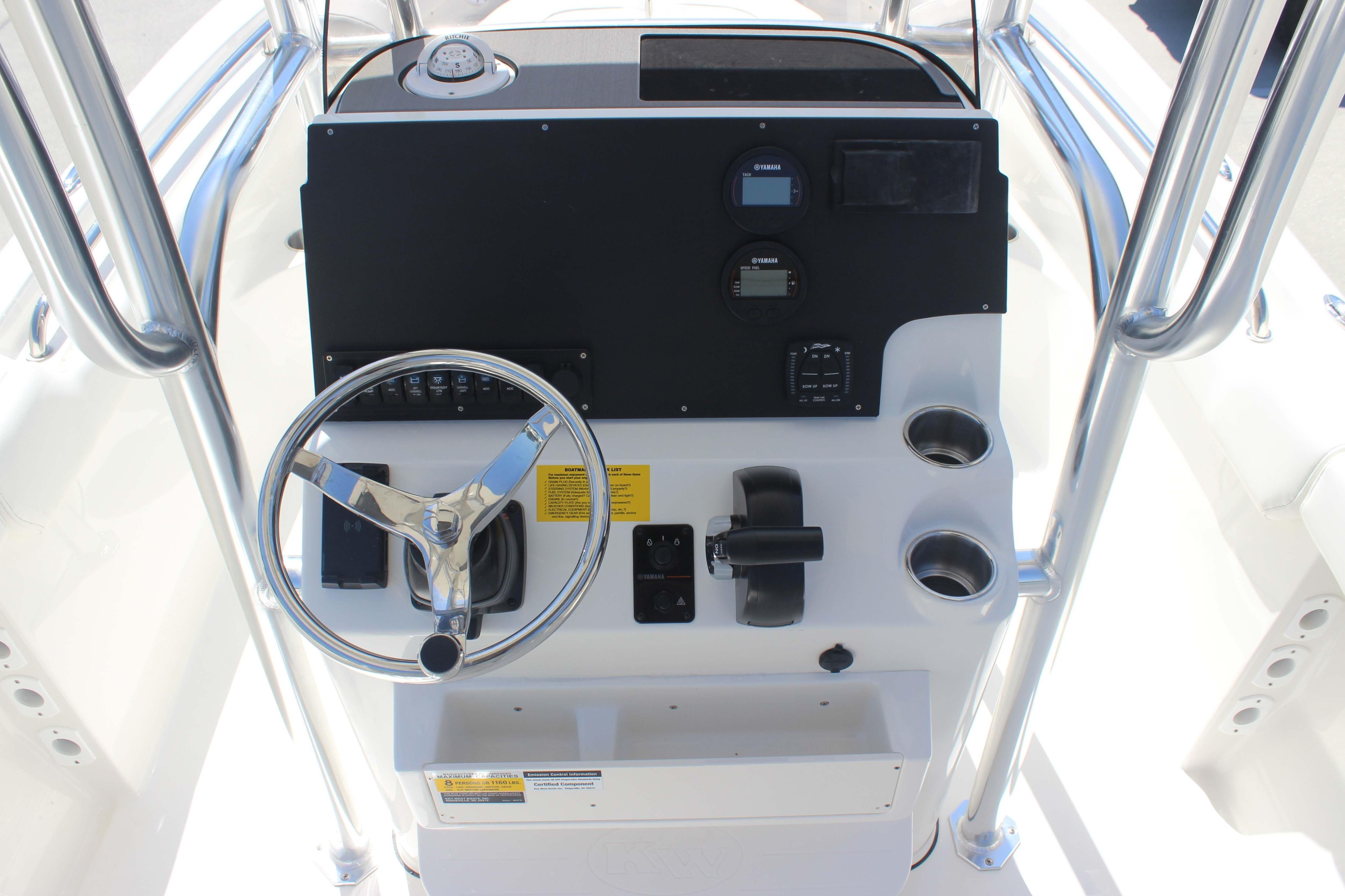 2026 Key West 203 FS boat console with steering wheel and controls.