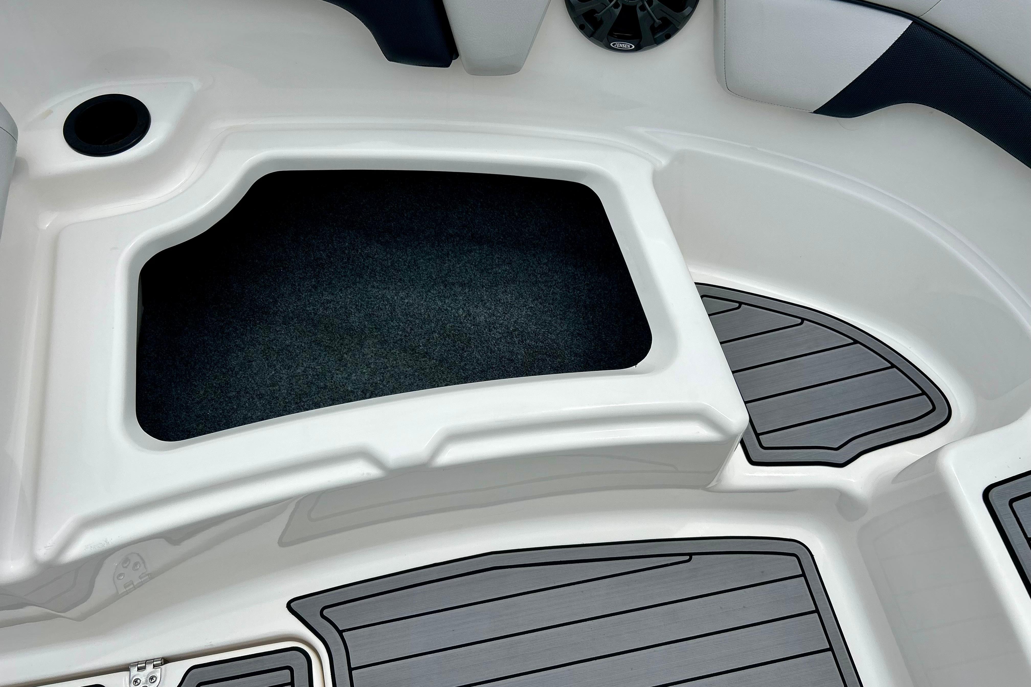 2015 Yamaha AR210 boat interior storage compartment with sleek design and non-slip flooring.