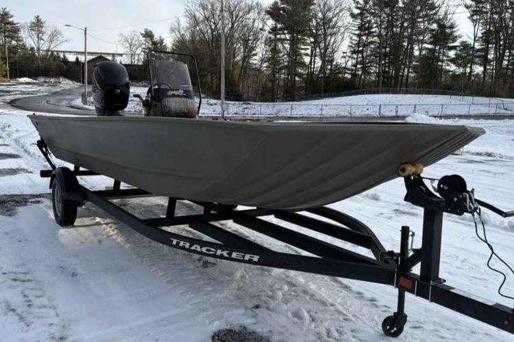2026 Tracker Grizzly 2072 CC boat on trailer in snowy landscape.