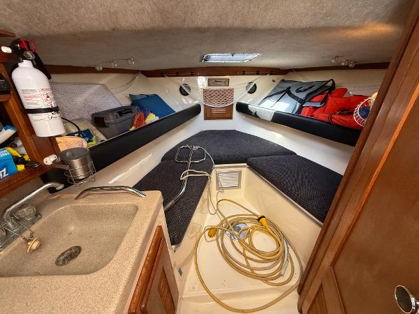 2001 Albemarle 280 Express Sport Fisherman cabin with sink, storage, and seating.