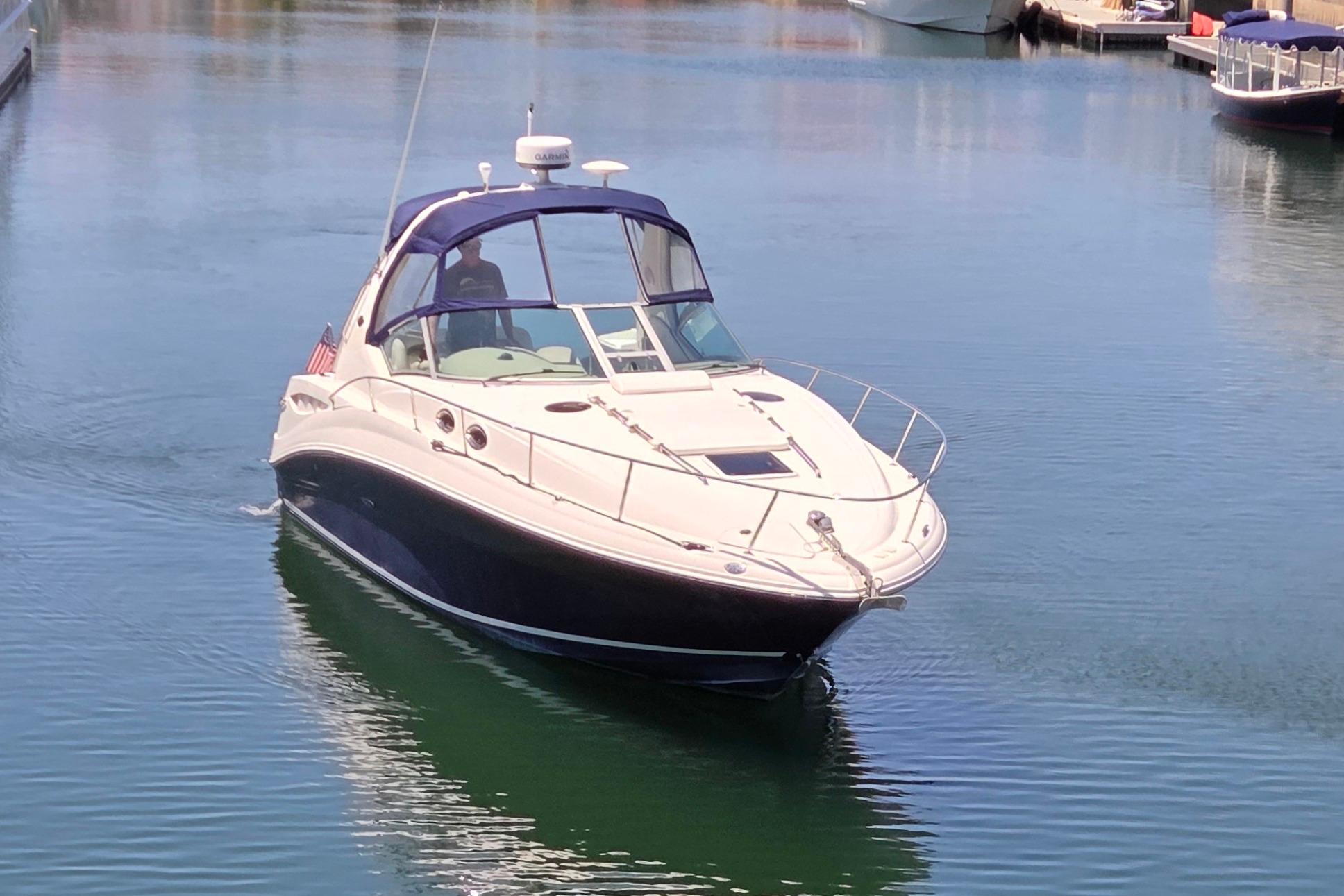 2006 Sea Ray Sundancer 320 cruising in calm marina waters.