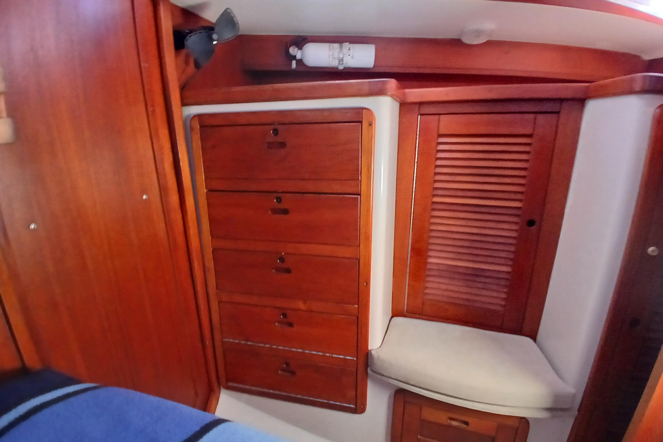 Interior of 1995 Catalina 42 MkII sailboat with wooden cabinetry and storage drawers.