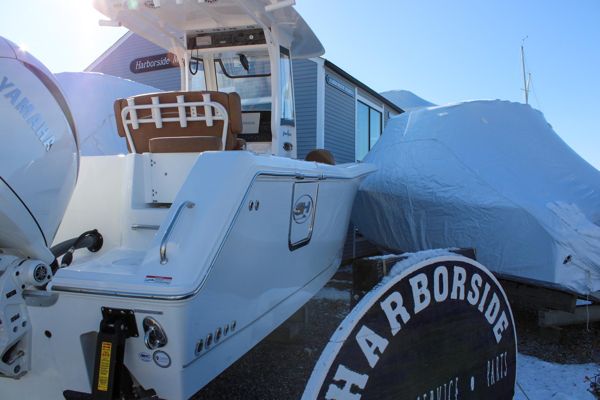 2026 Sea Hunt Gamefish 25 boat at Harborside, covered for winter storage.