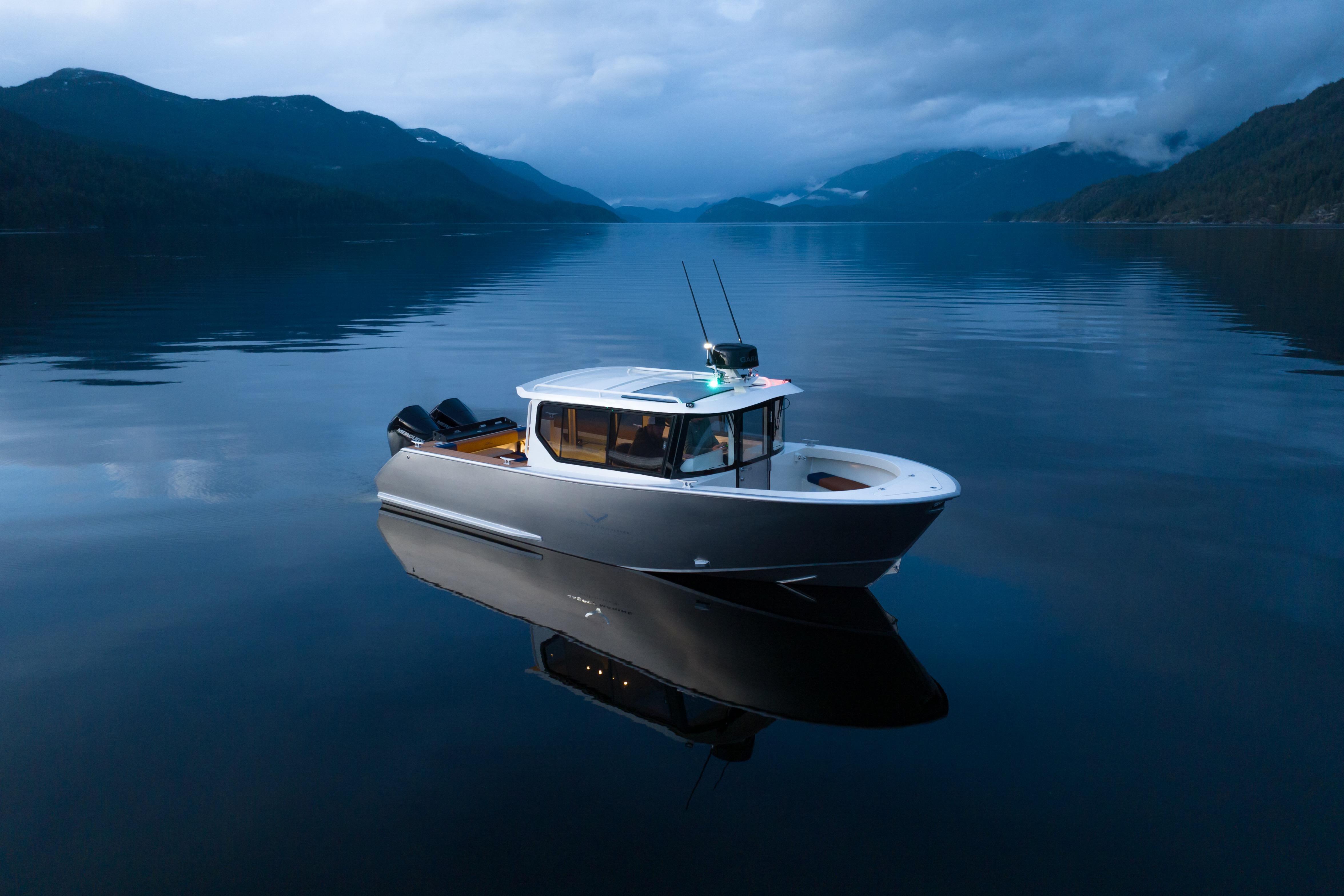 2026 Jasper Marine Defender 22 boat on serene lake with mountainous backdrop at dusk.