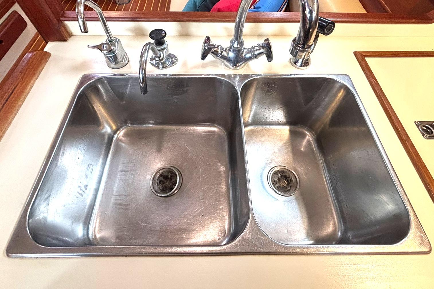 Stainless steel double sink in 2001 Island Packet 380 yacht galley.