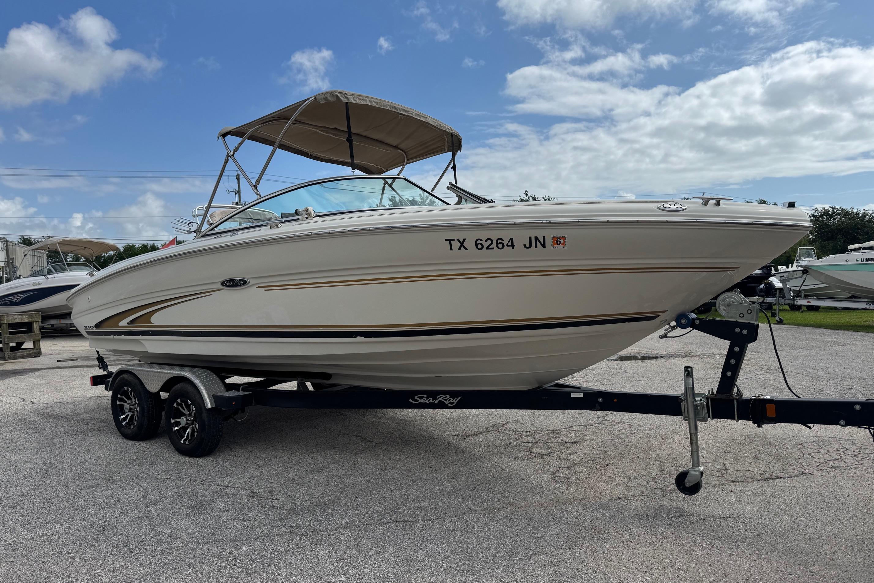 2001 Sea Ray 210 Bow Rider boat on trailer under blue sky.