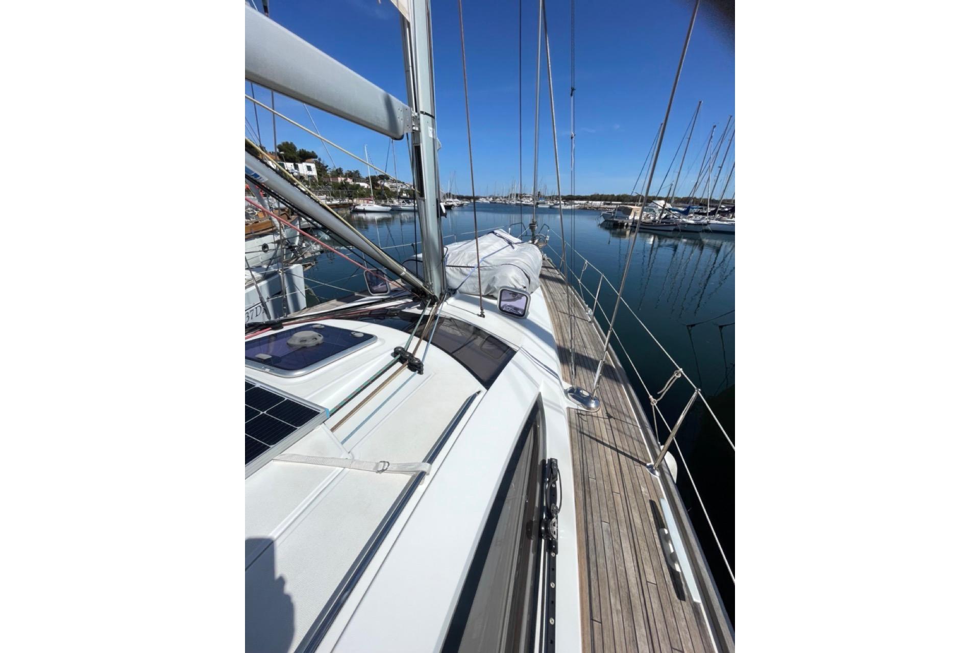 Jeanneau Sun Odyssey 50 DS sailboat docked in a serene marina, 2015 model.