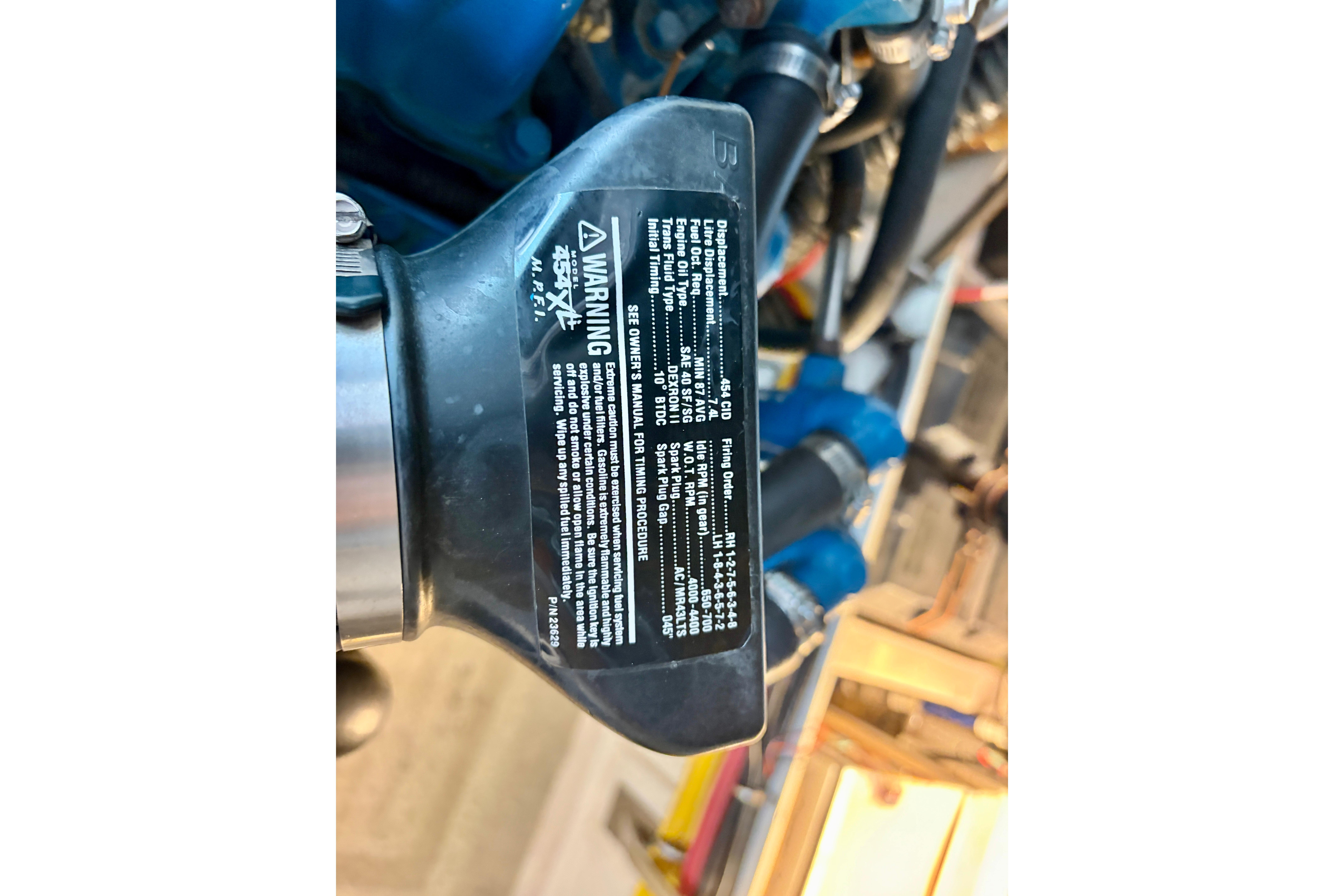 Engine label on a 1999 Tiara Yachts 2900 Coronet, displaying specifications and warnings.