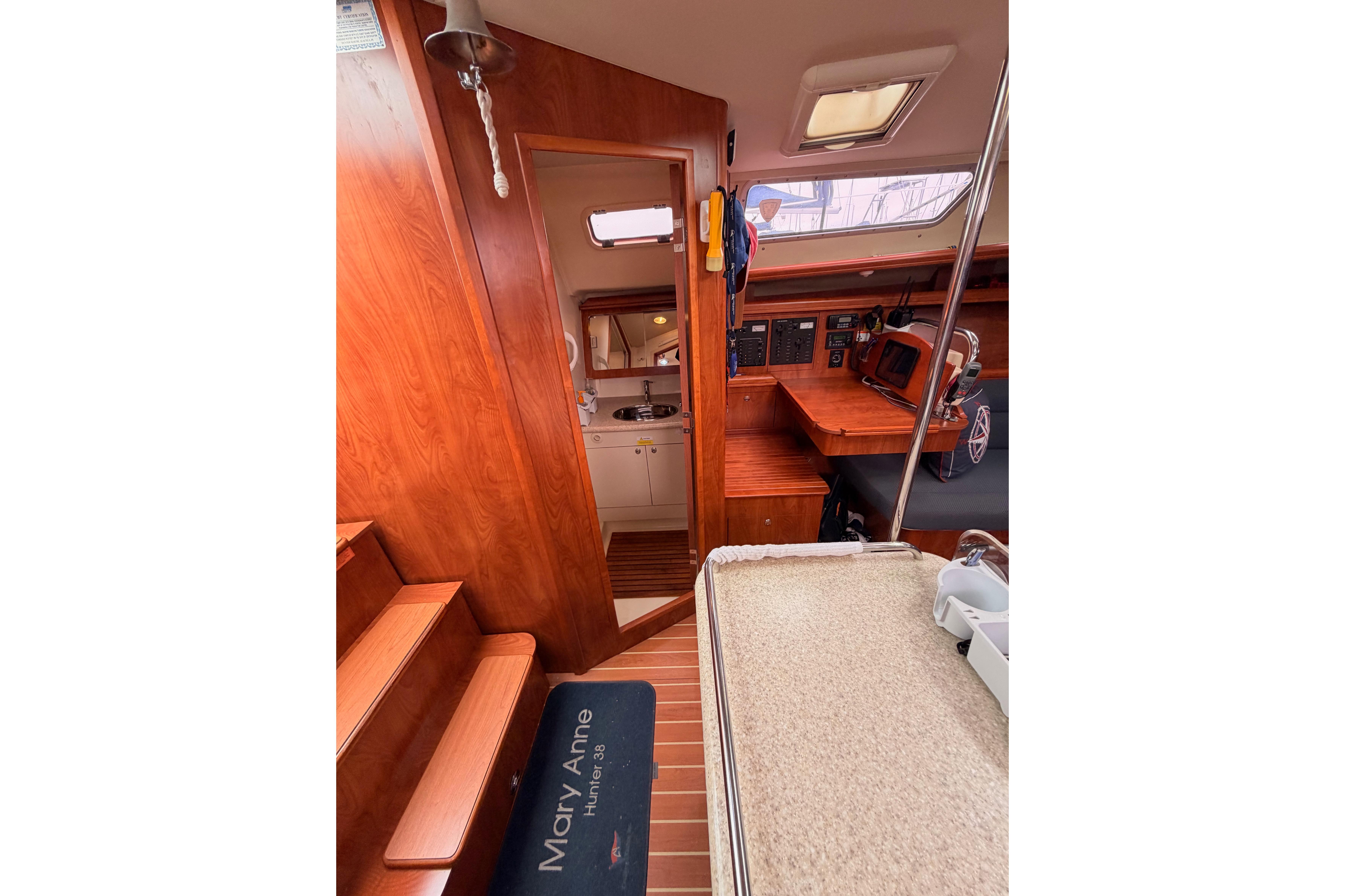 Interior of 2009 Hunter 38 sailboat with wood finish and navigation equipment.
