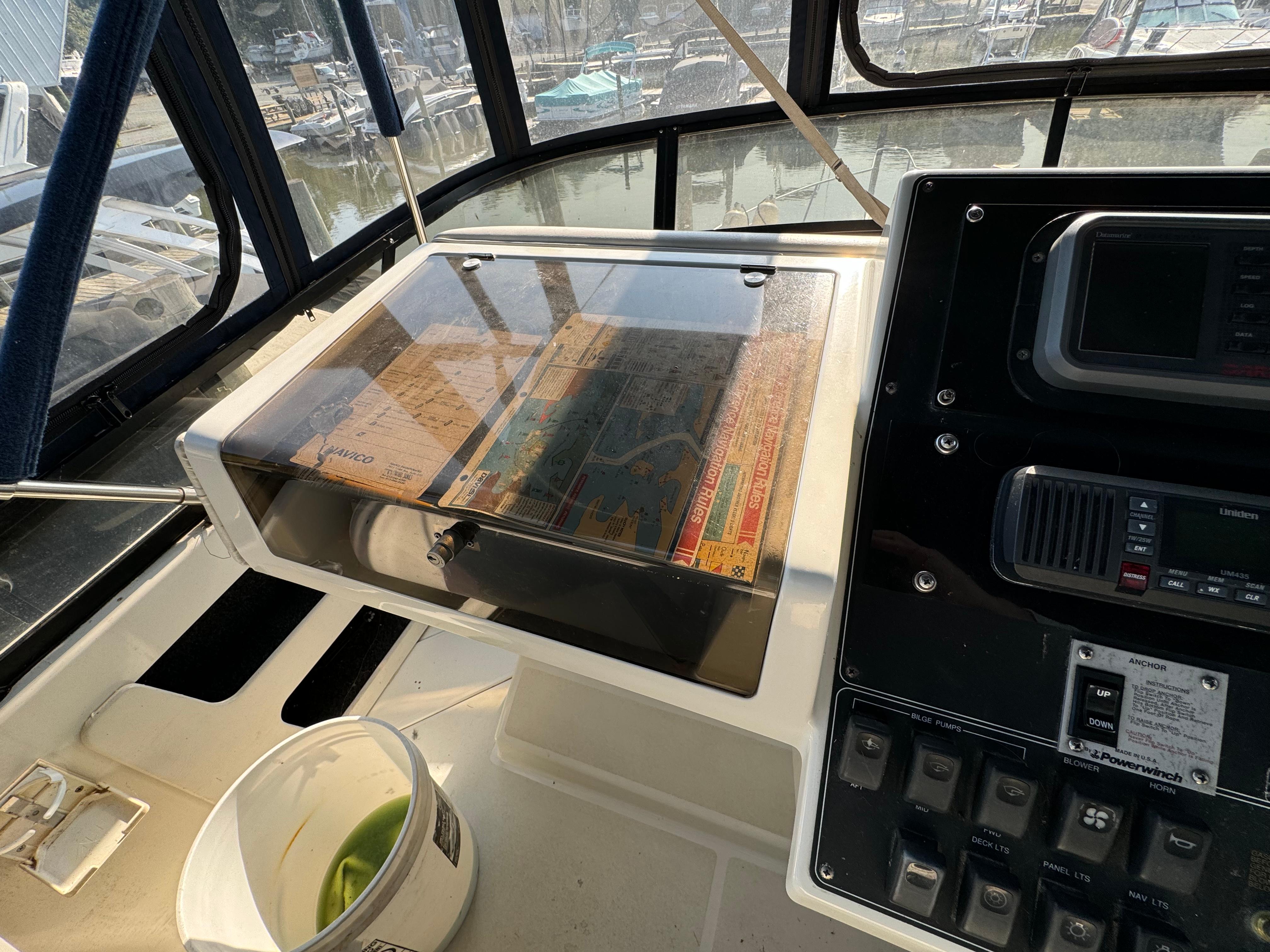 1991 Carver 33 Aft Cabin helm with navigation equipment and chart display.