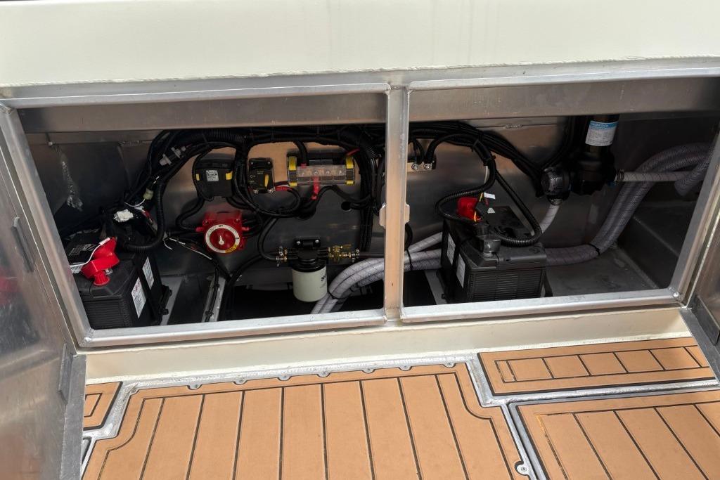 2025 Ortun Express Cruiser engine compartment with batteries and wiring.