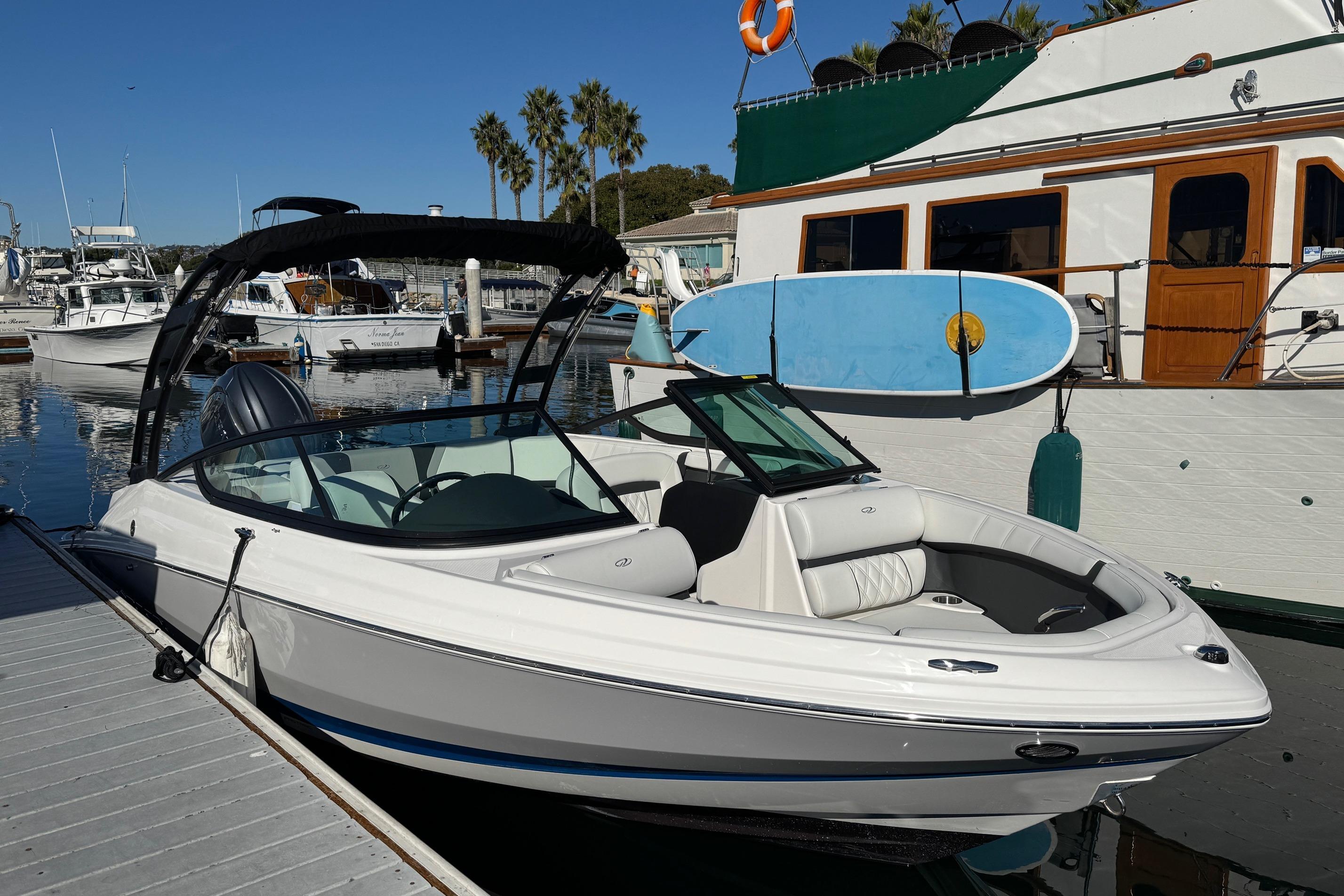 2026 Regal 21 OBX boat docked at marina with clear blue sky.