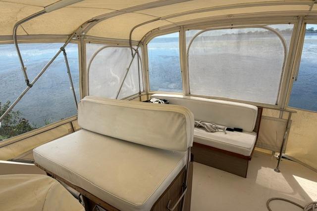 1980 Chris-Craft 381 Catalina boat interior with white seating and panoramic windows.