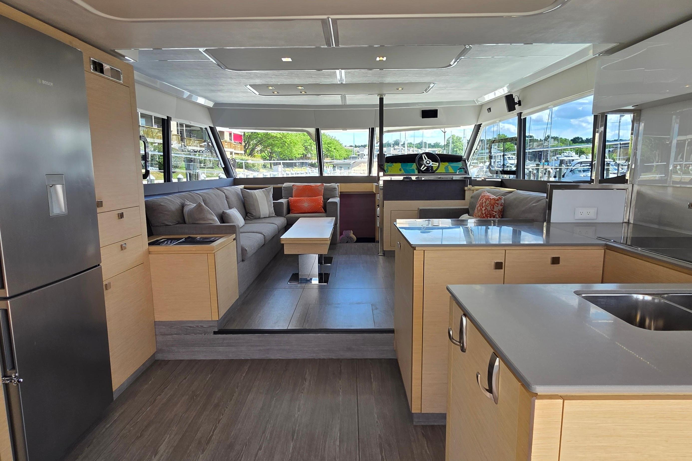 Luxurious interior of 2018 Fountaine Pajot Motor Yacht 44 with modern kitchen and spacious seating area.