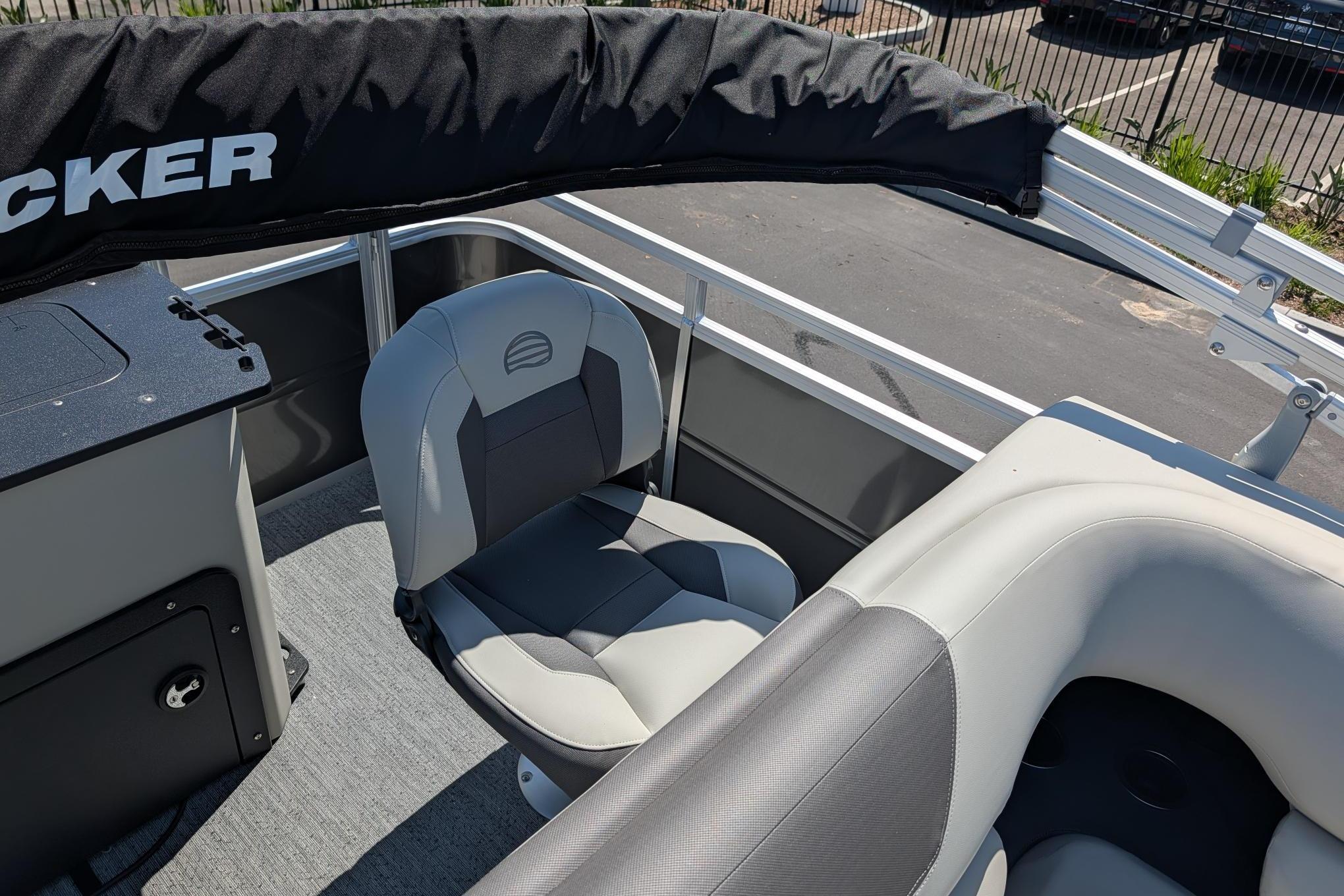 2026 Sun Tracker Fishin' Barge 22 DLX interior with seating and railing.