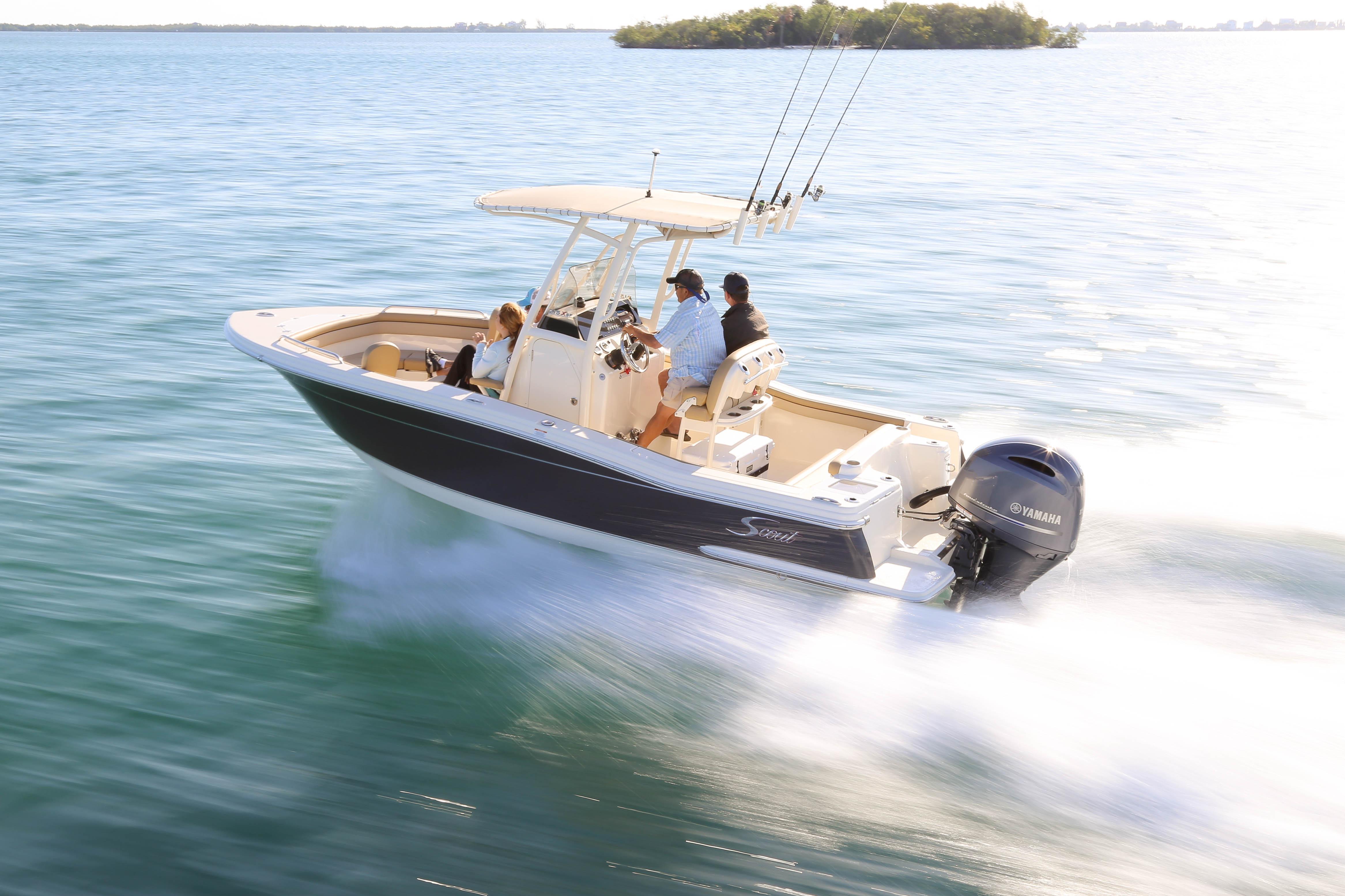 2018 Scout 215 XSF boat cruising on open water with passengers.