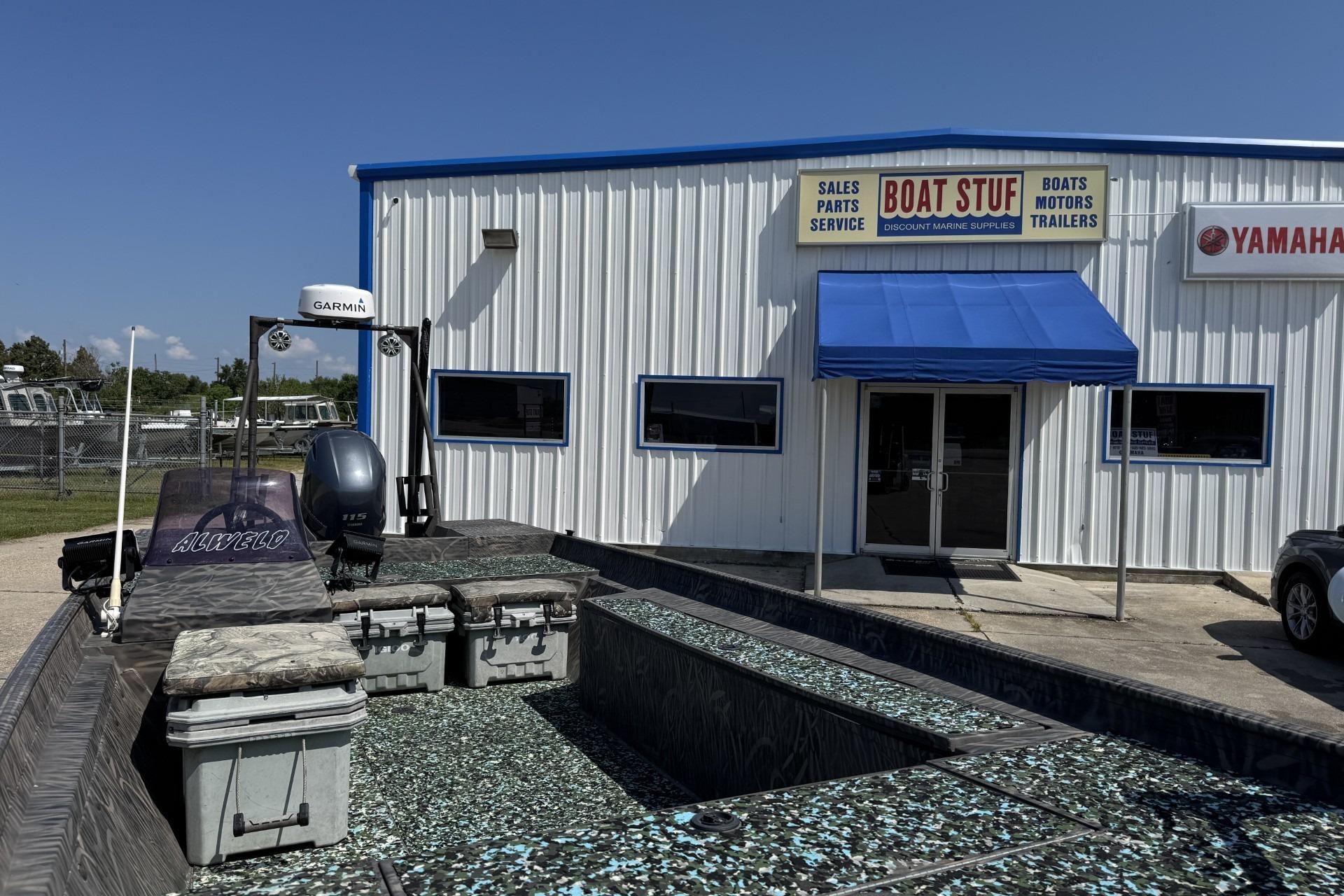 2022 Alweld 2270 Large Flat Bottom boat outside marine supply store.