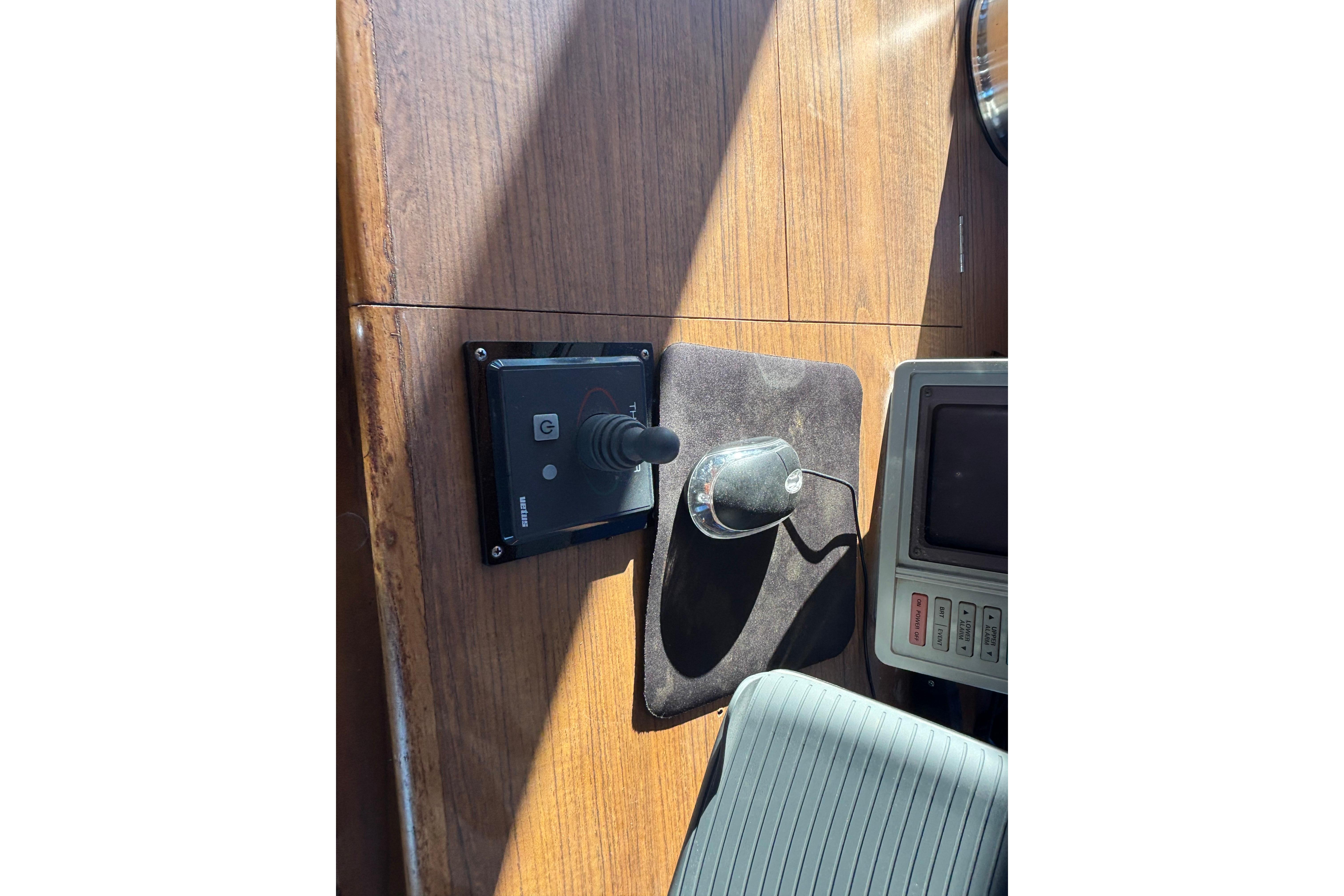 Control panel and joystick on 1989 Grand Banks 46 Classic yacht dashboard.