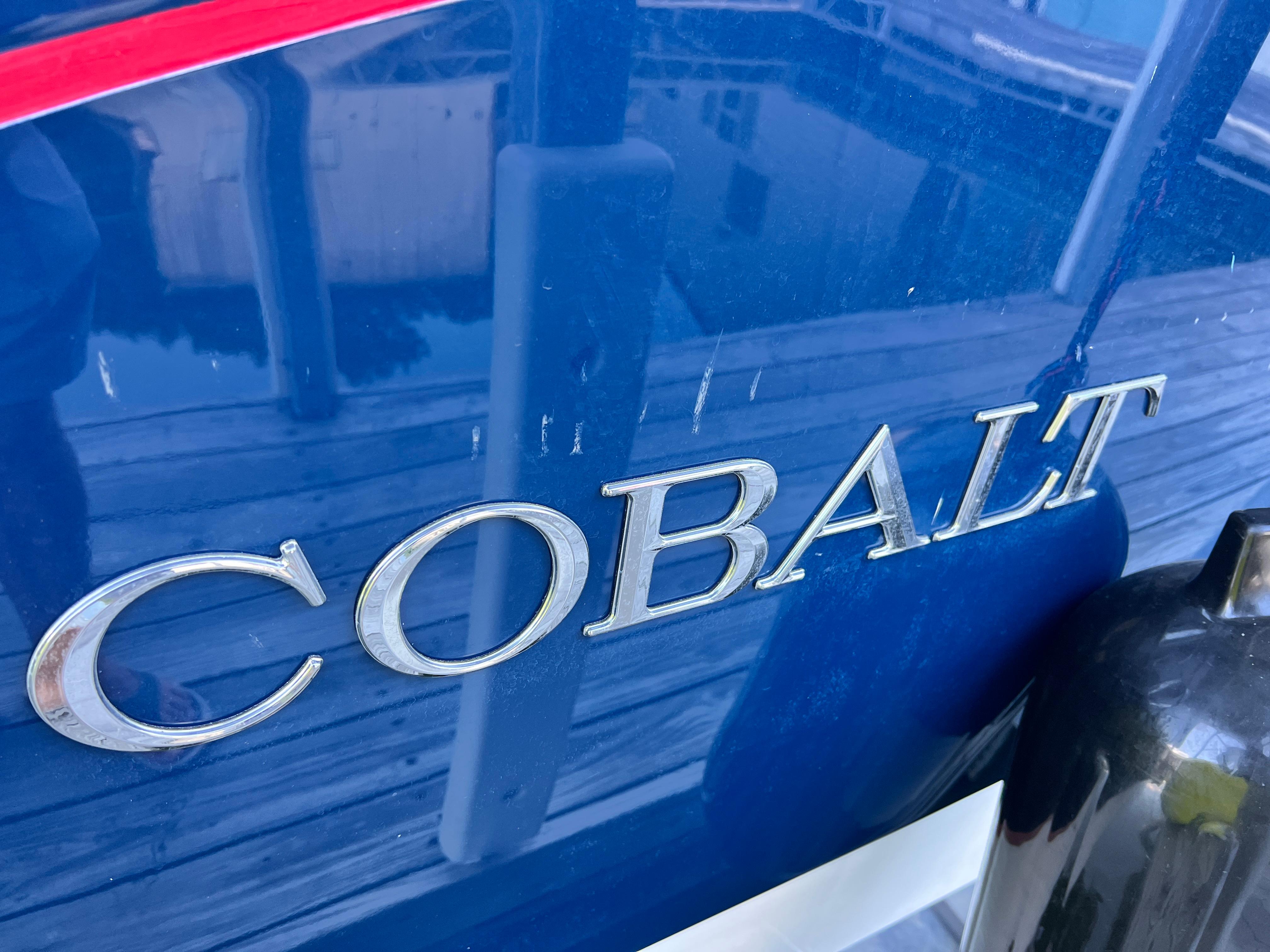 Close-up of 2021 Cobalt R5 boat nameplate in silver on blue hull.