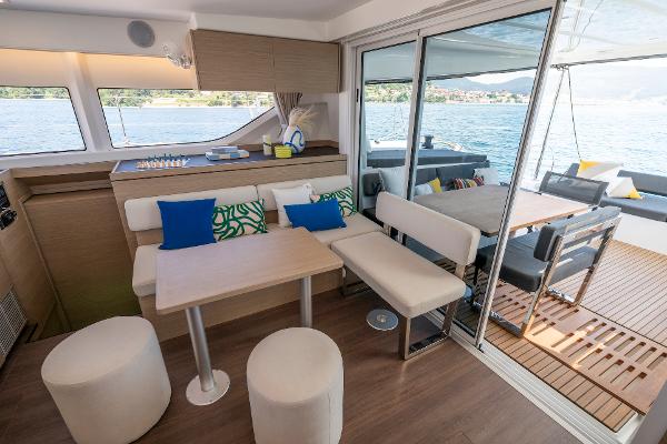 Luxurious interior of 2025 Lagoon 43 yacht with modern seating and scenic water view.
